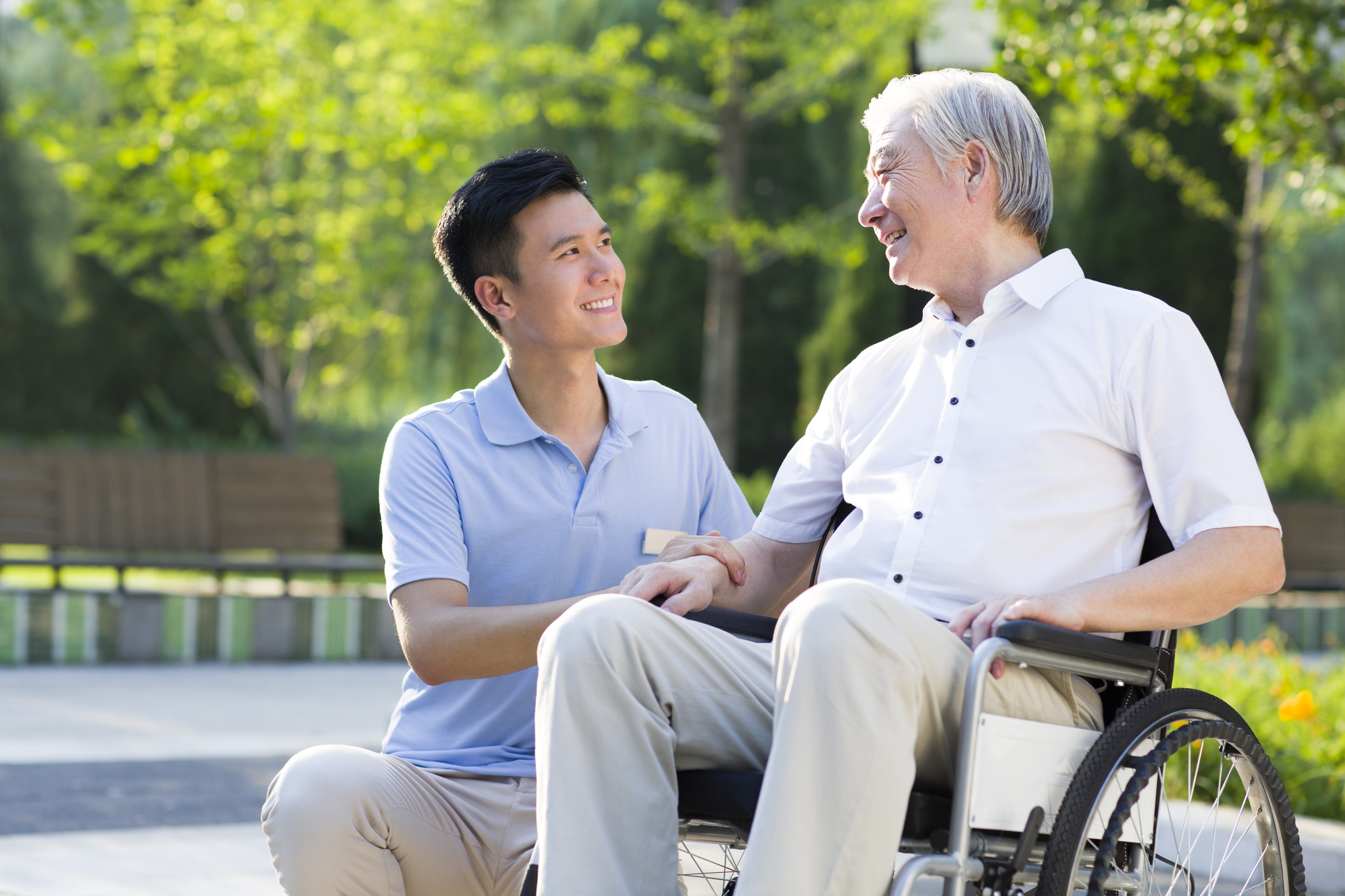 Wheelchair bound man with nursing assistant