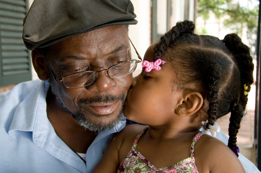 Grandfather gets kiss from granddaughter