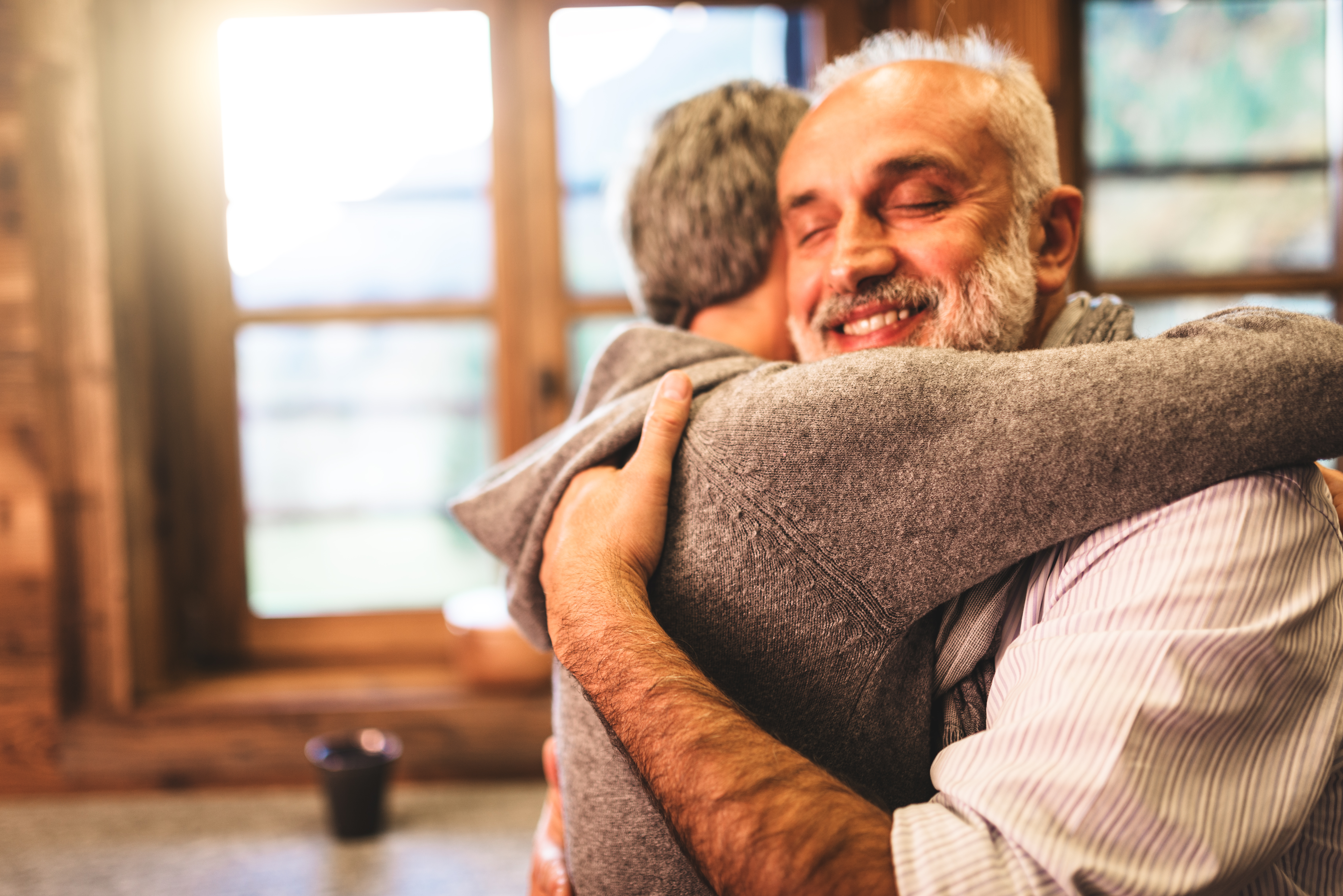 senior couple embracing passionate in the house - support concept