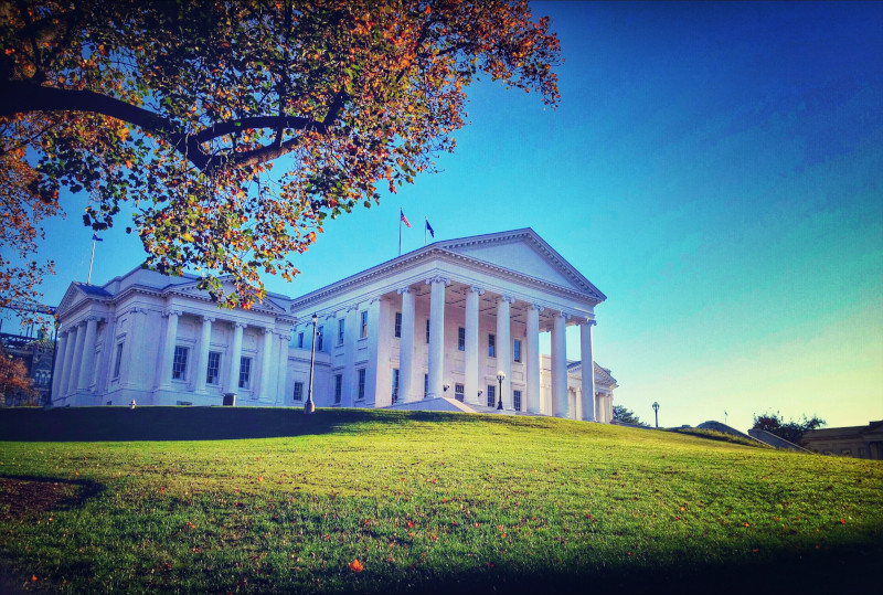 Virginia State Capitol Building On Field Against Blue Sky