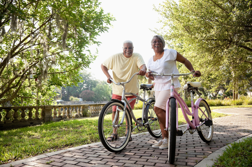 Senior African American couple riding bicycles