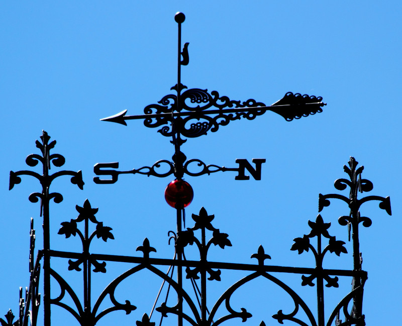 Rooftop Weathervane with Deep Blue Sky