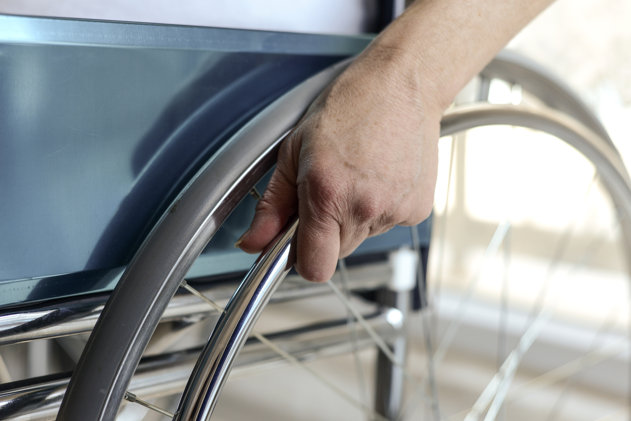 Senior Woman's Hand On Wheelchair