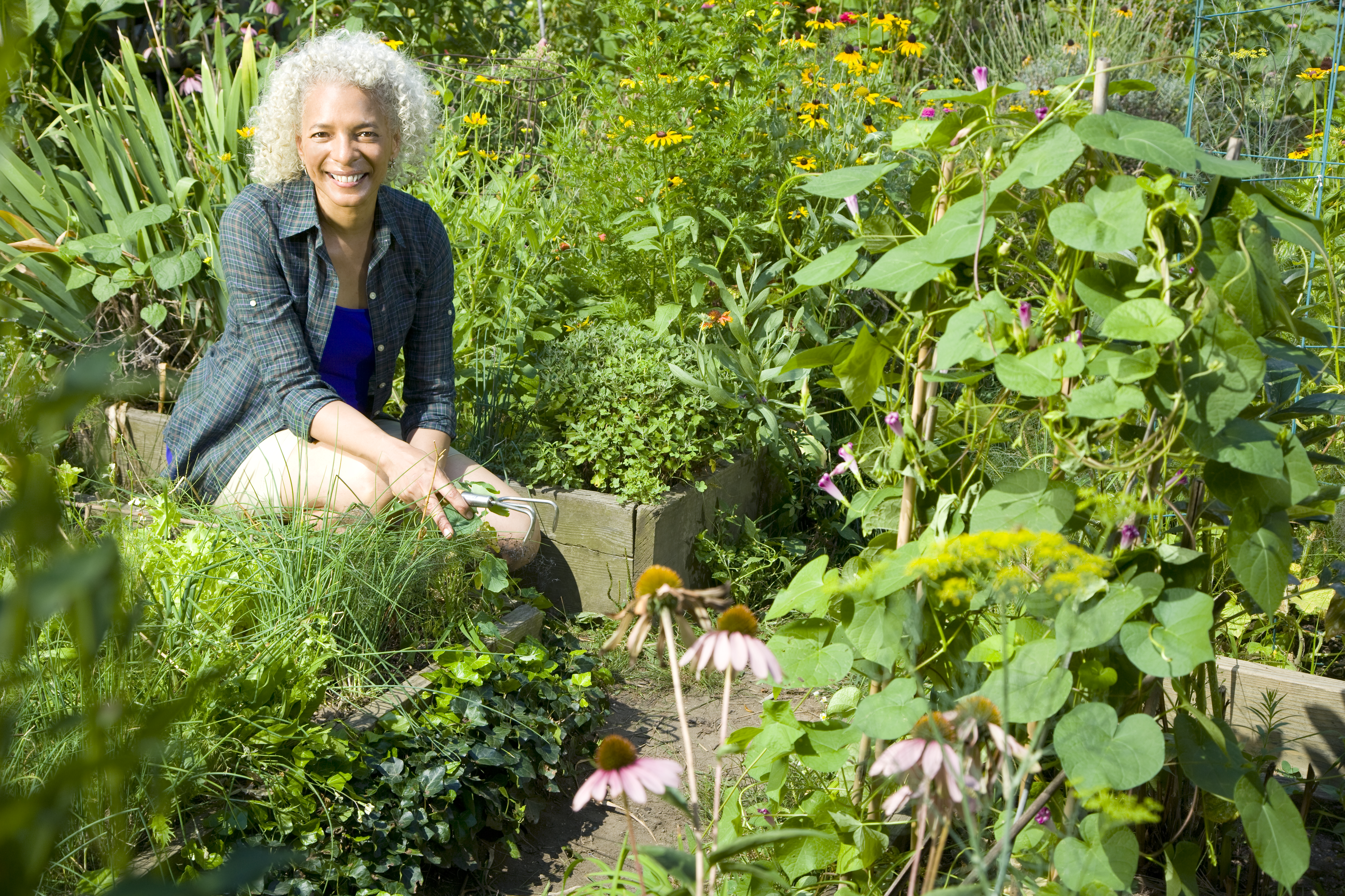 Woman sitting in a community garden