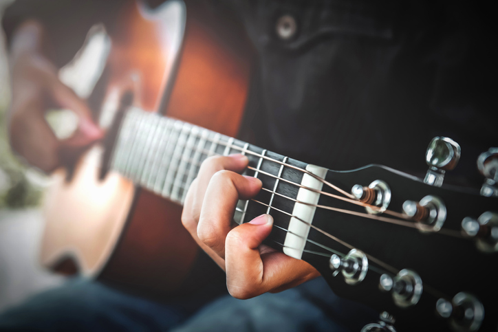 woman playing acoustic guitar