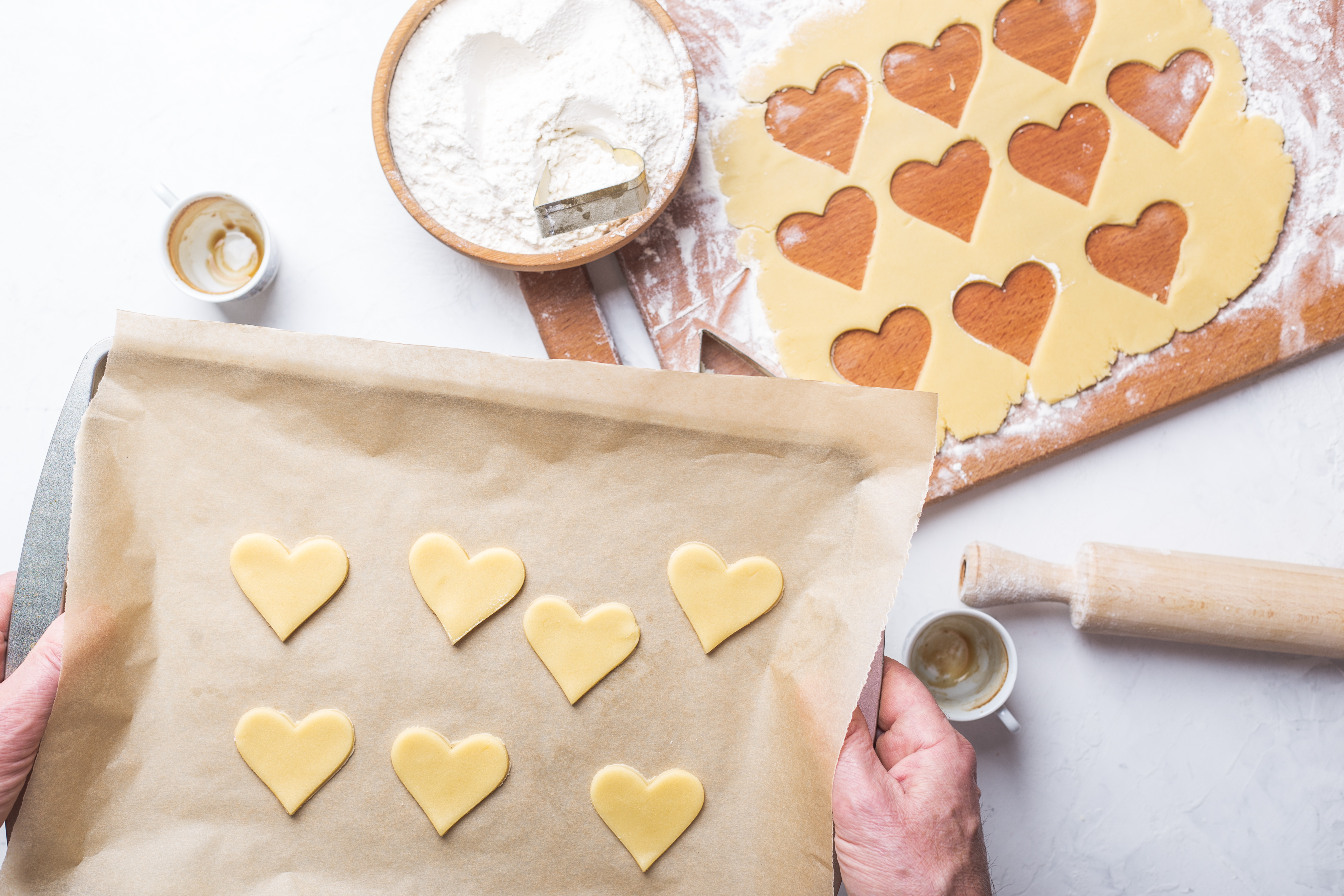 Man  making Valentines day cookies, overheard view of holiday baking