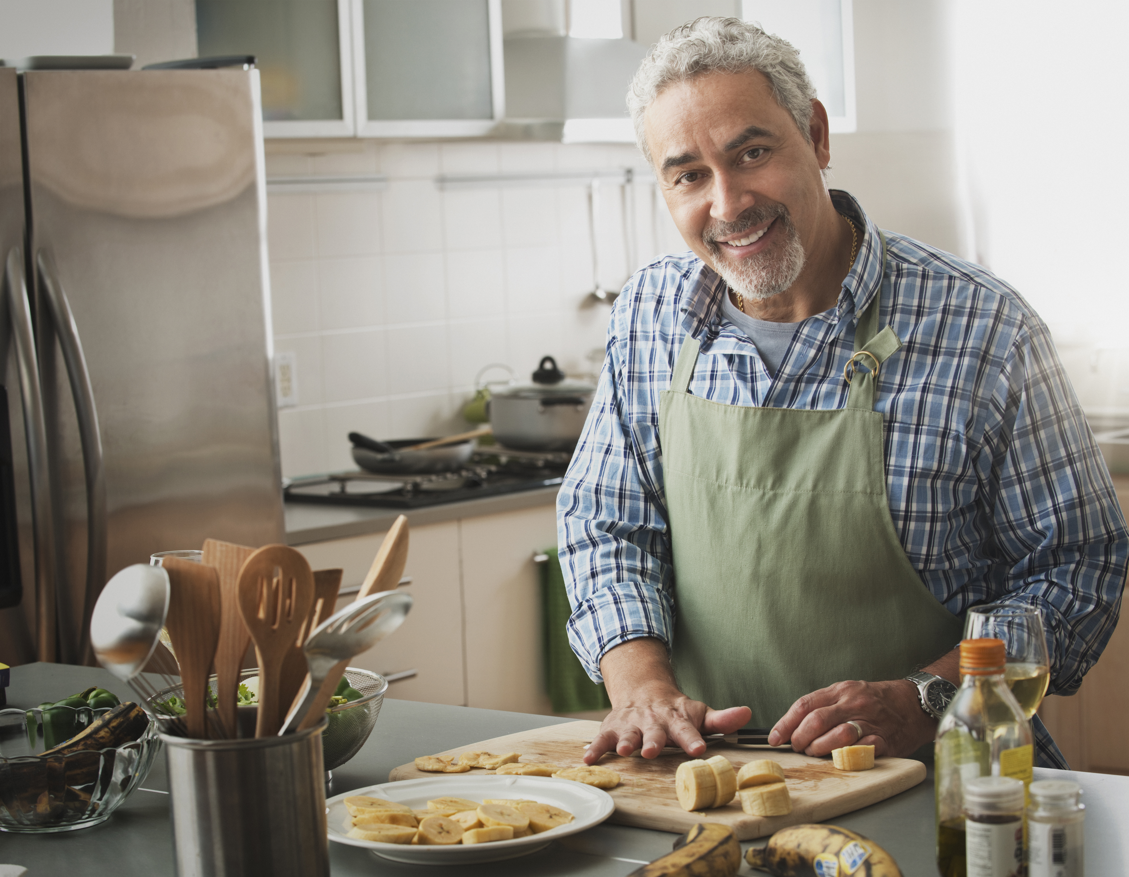 Hispanic man cooking in kitchen