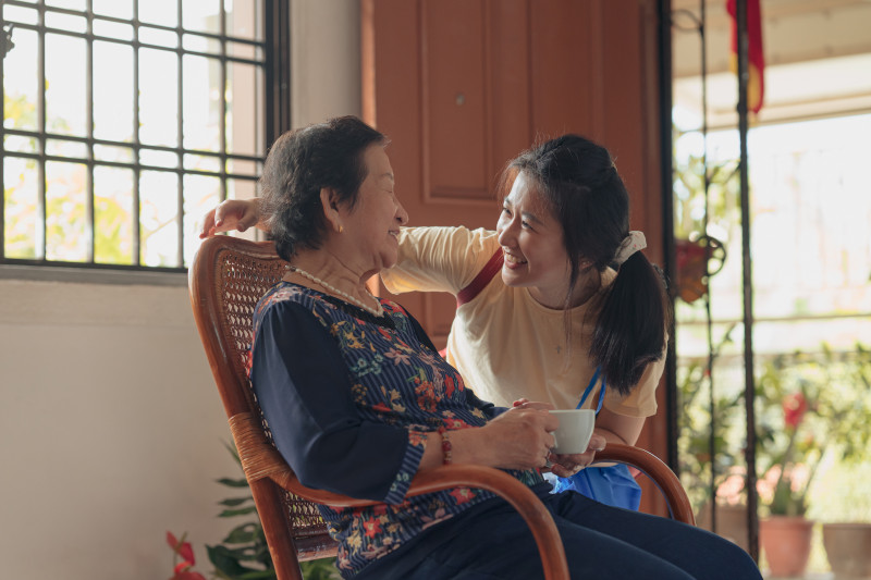 Asian granddaughter visiting her grandmother