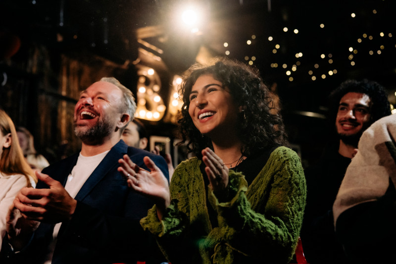 Theatre attendees applaud.