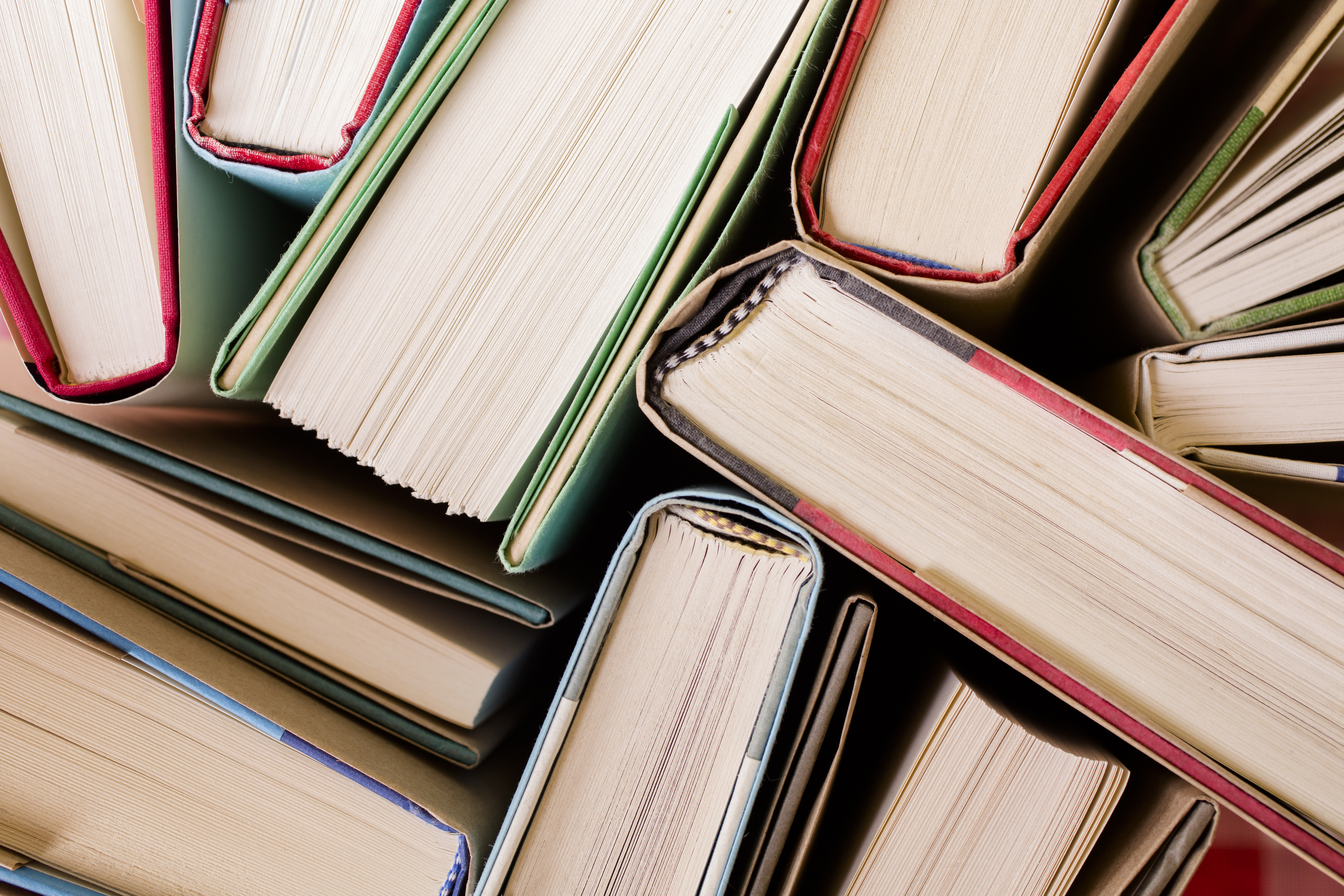 High angle view of many hardback books. Library or school.