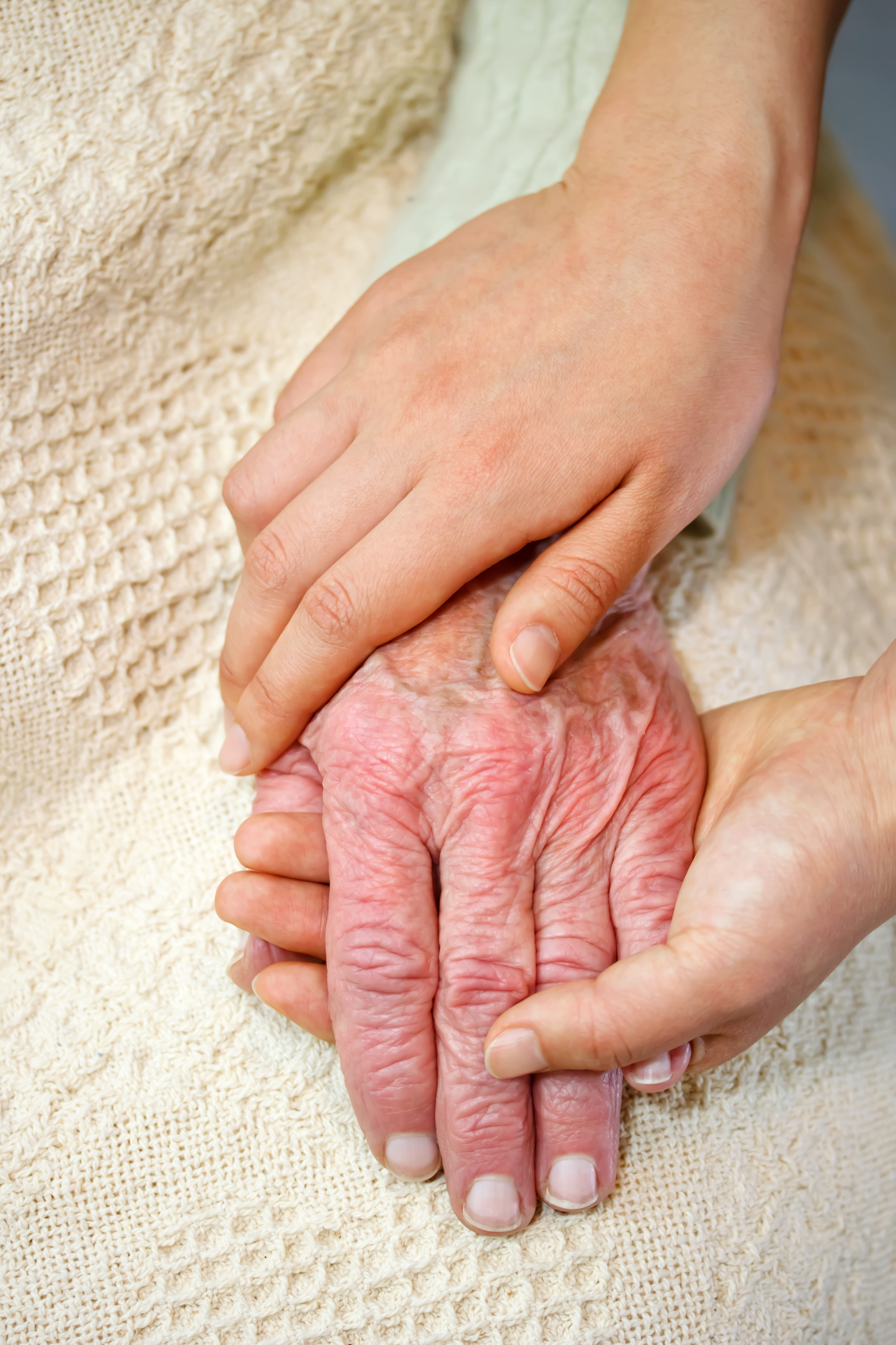 Young hands embracing old hands