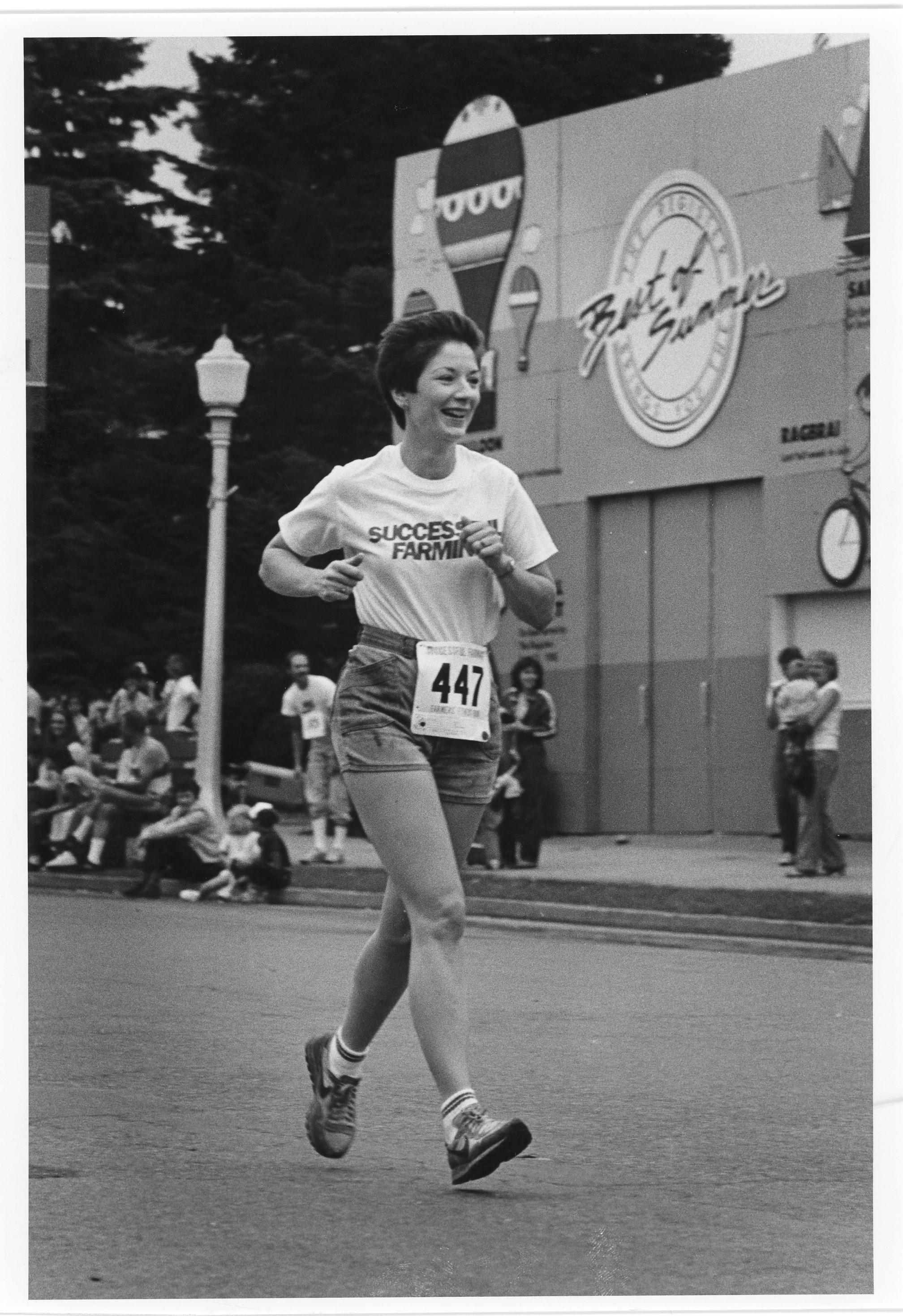 Black and white image of a woman running a marathon