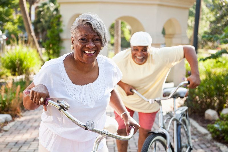 Senior African American couple riding bicycles