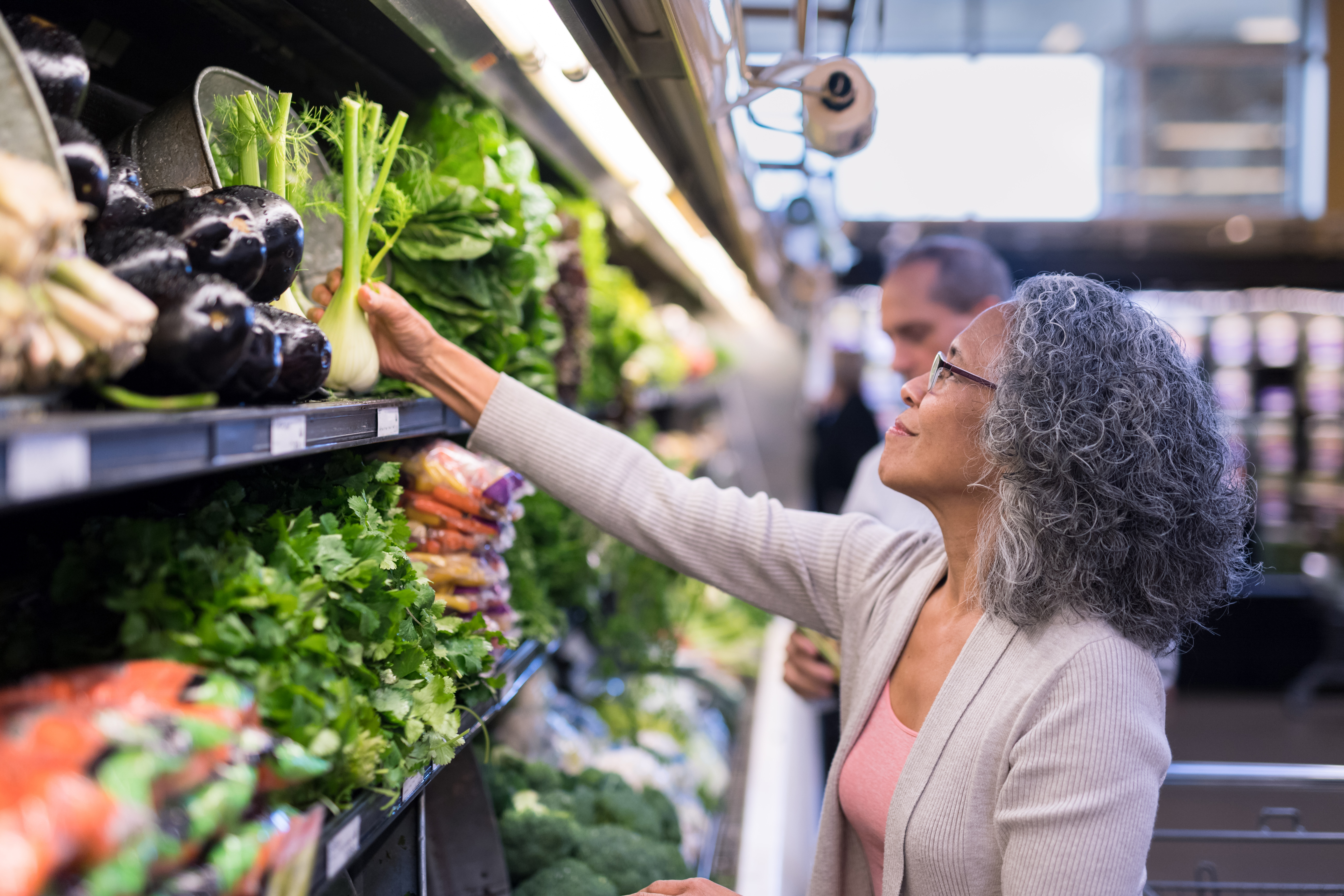 An interracial senior couple goes grocery shopping together