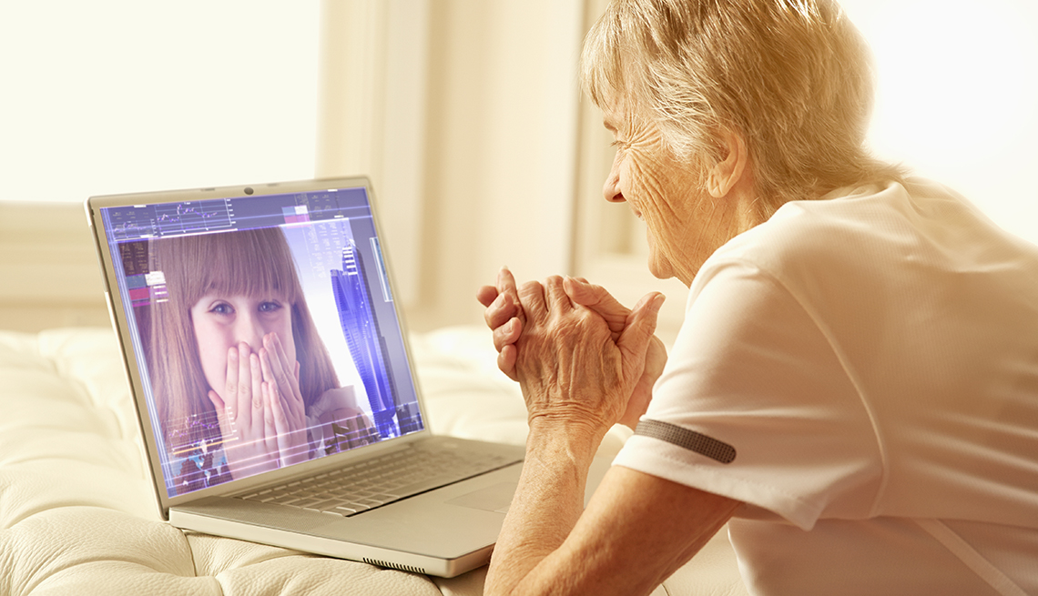 Older Caucasian woman video-chatting with granddaughter