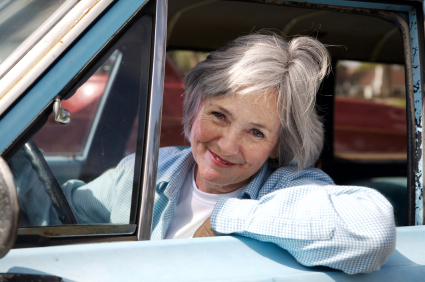 Happy senior out driving the old car