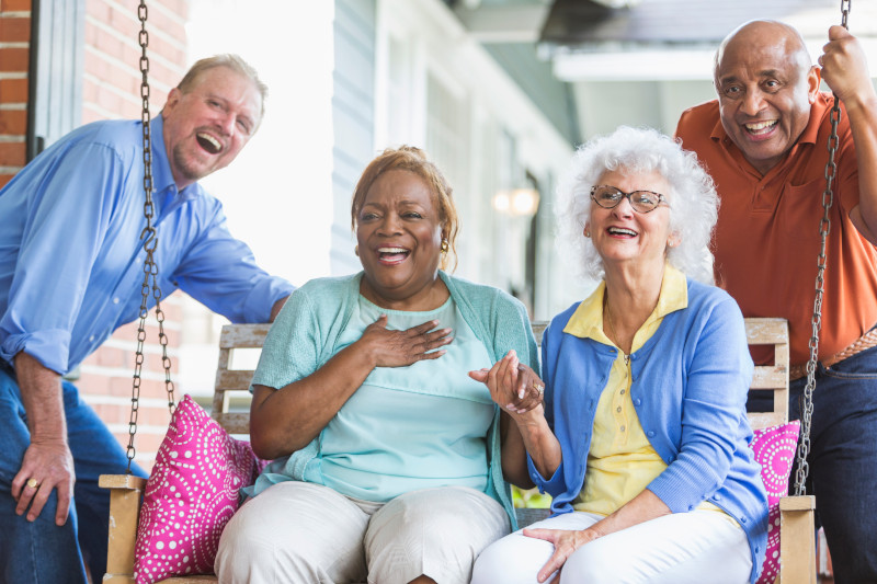 Group of multiracial seniors on porch swing