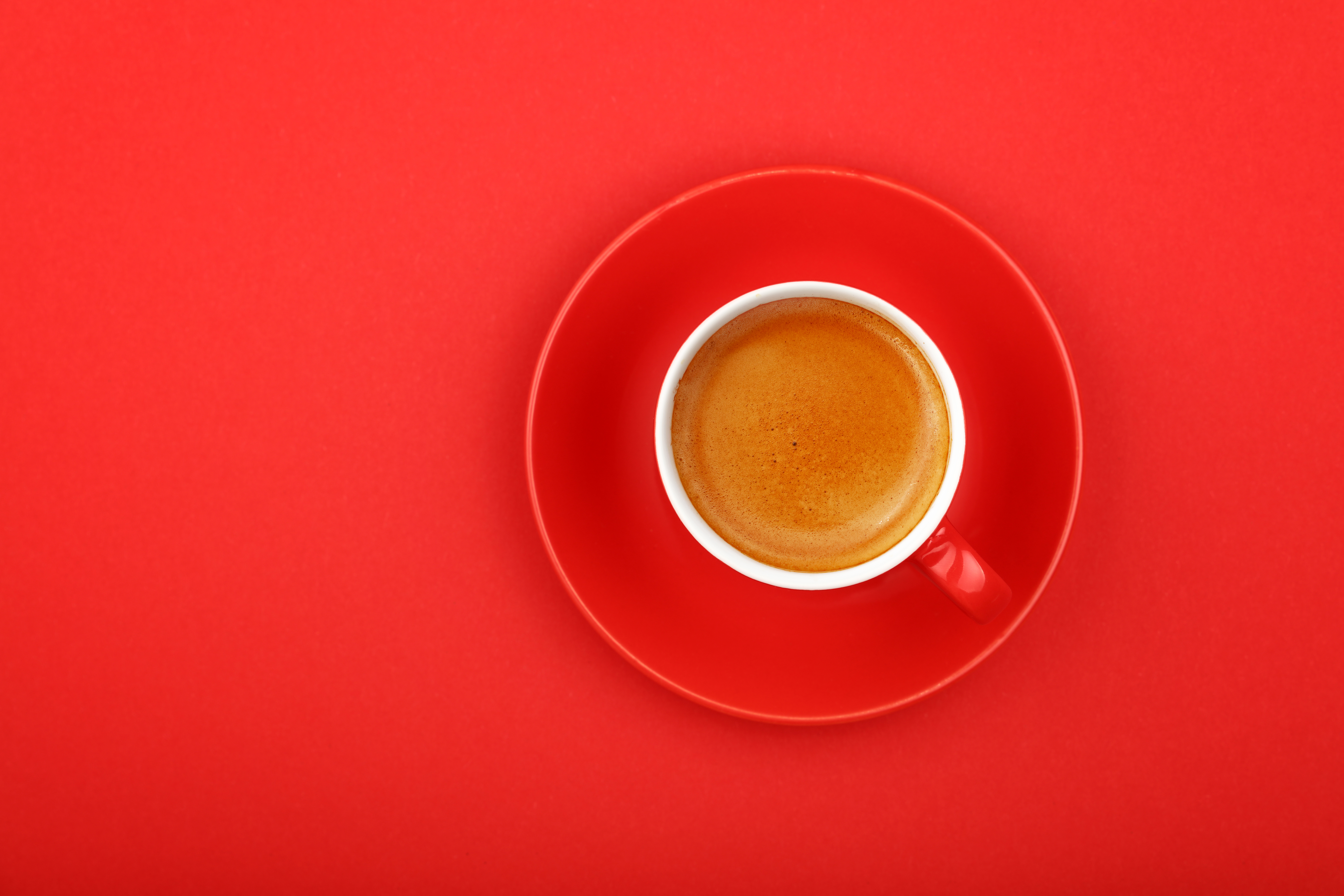 Directly Above Shot Of Coffee In Cup On Red Background