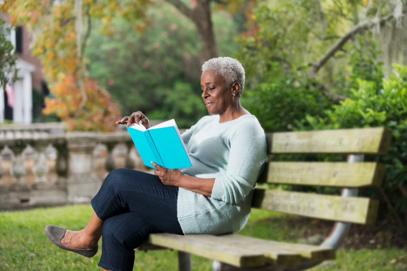 Senior black woman reading a book