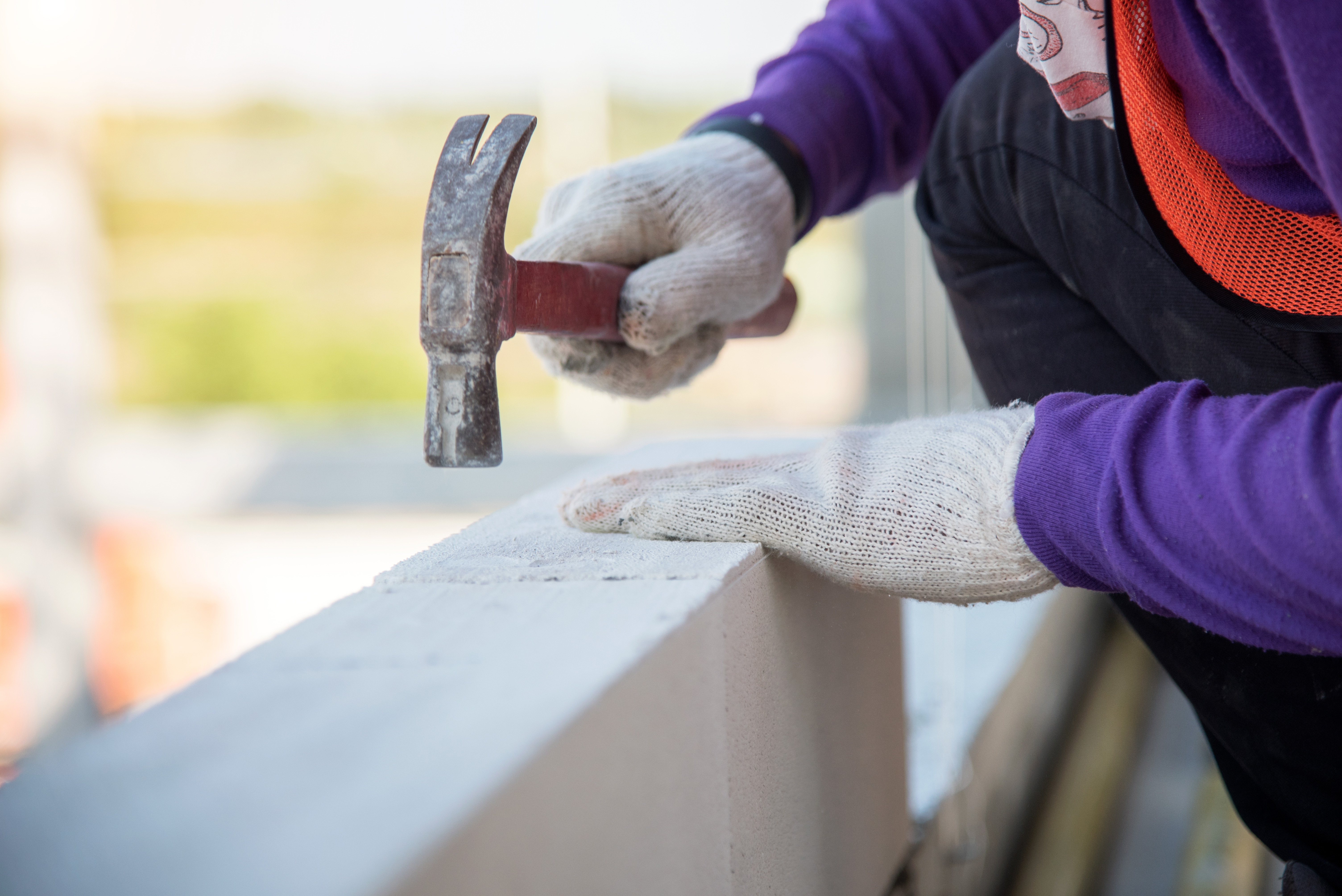 construction mason worker bricklayer installing calcium silicate brick