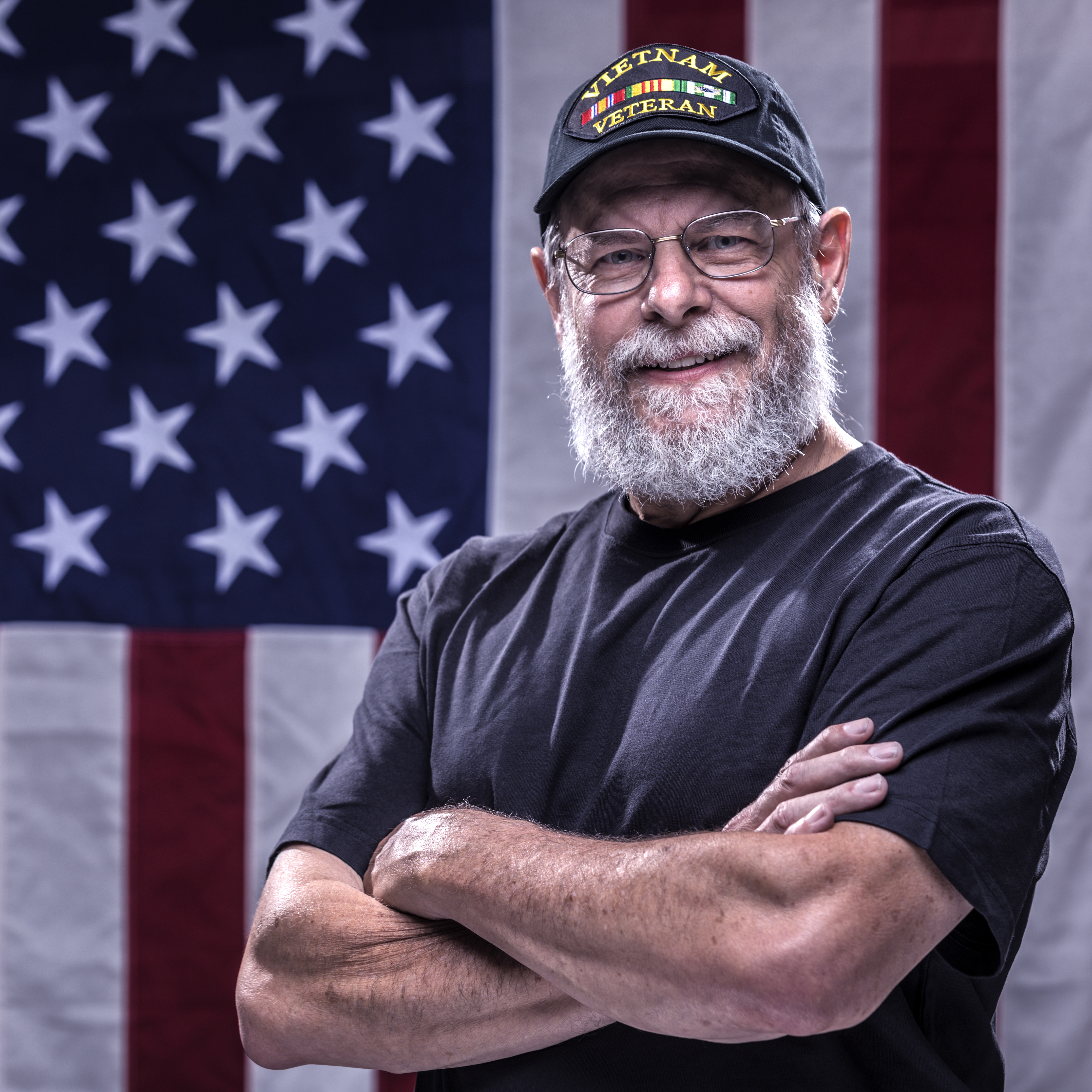 Arms Crossed USA Vietnam Veteran and American Flag