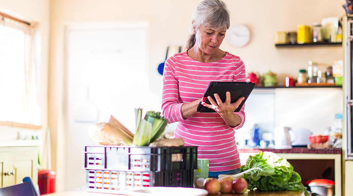 Woman receiving grocery delivery.