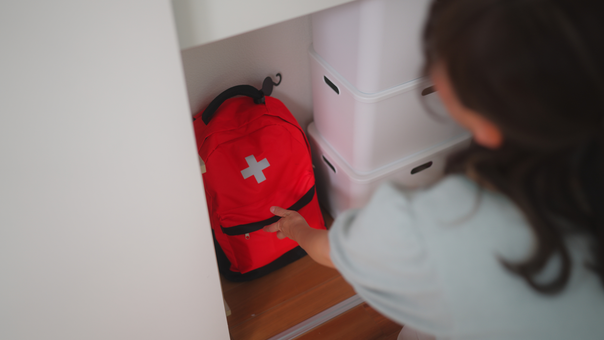 Woman preparing emergency bag at home