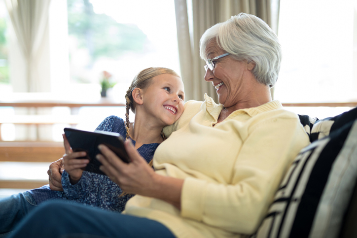 Photo courtesy of Wavebreakmedia (https://www.istockphoto.com/photo/smiling-granddaughter-and-grandmother-using-digital-tablet-on-sofa-gm838035980-136348911)