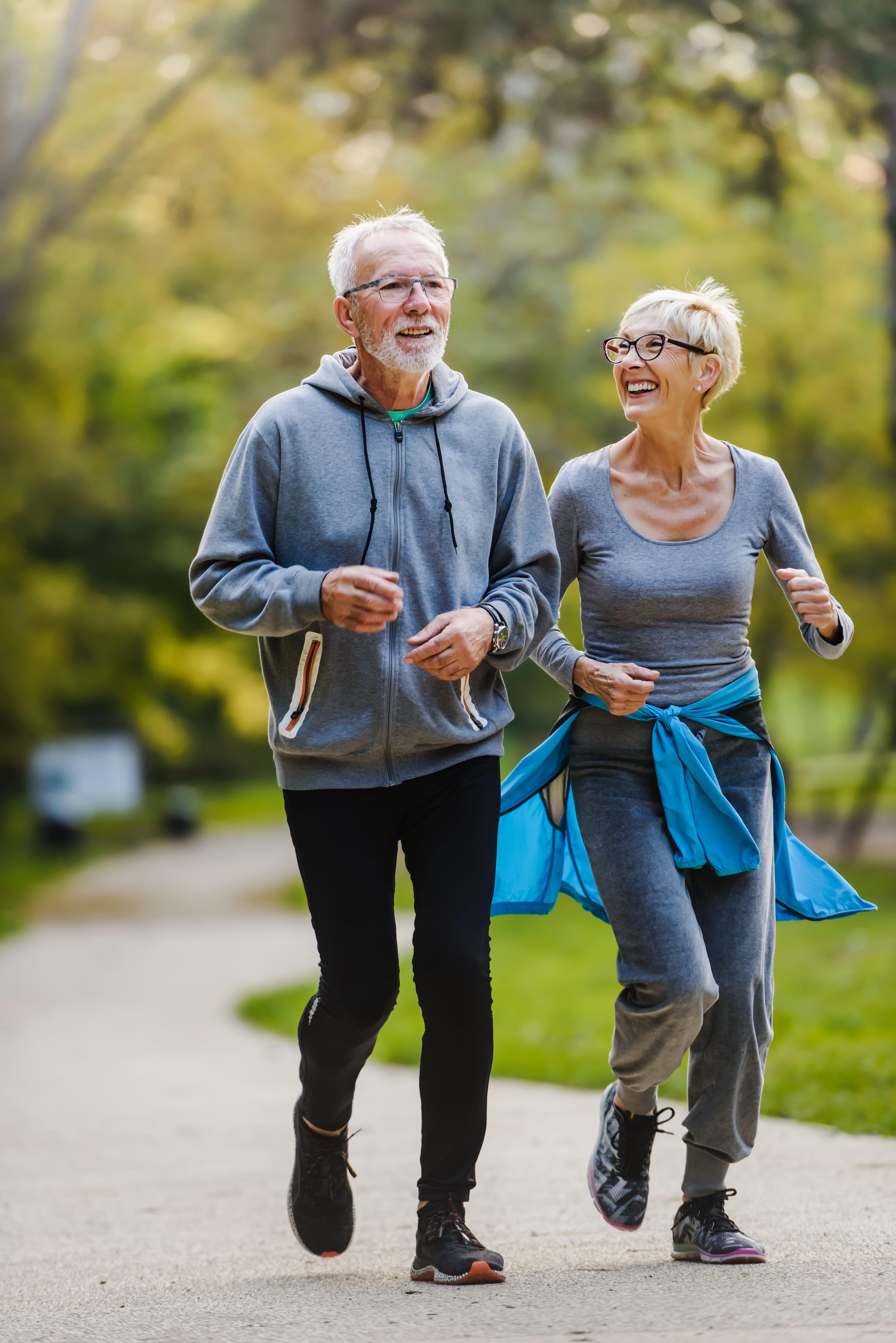 Smiling senior couple jogging in the park
