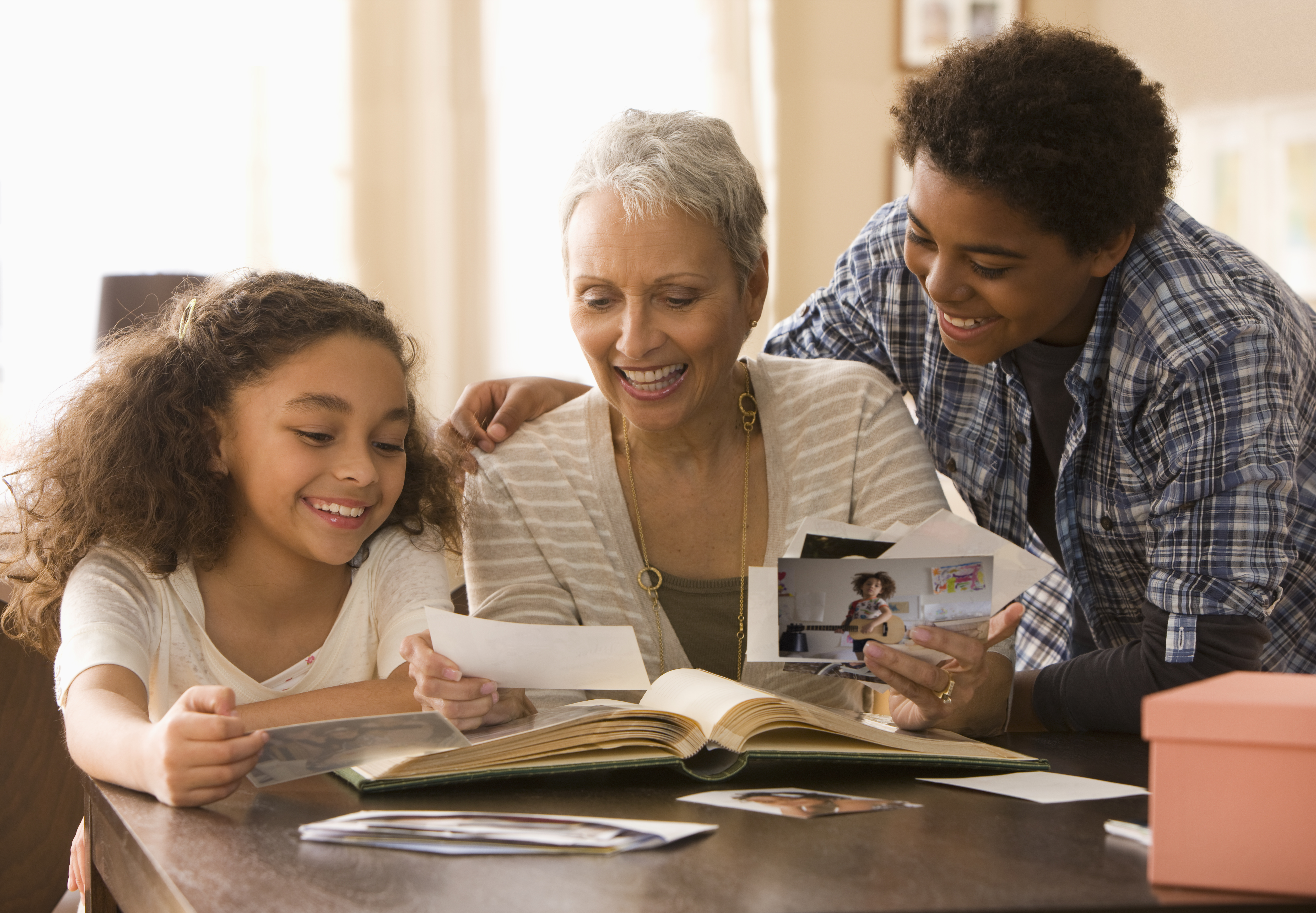 Grandmother and grandchildren looking at photographs