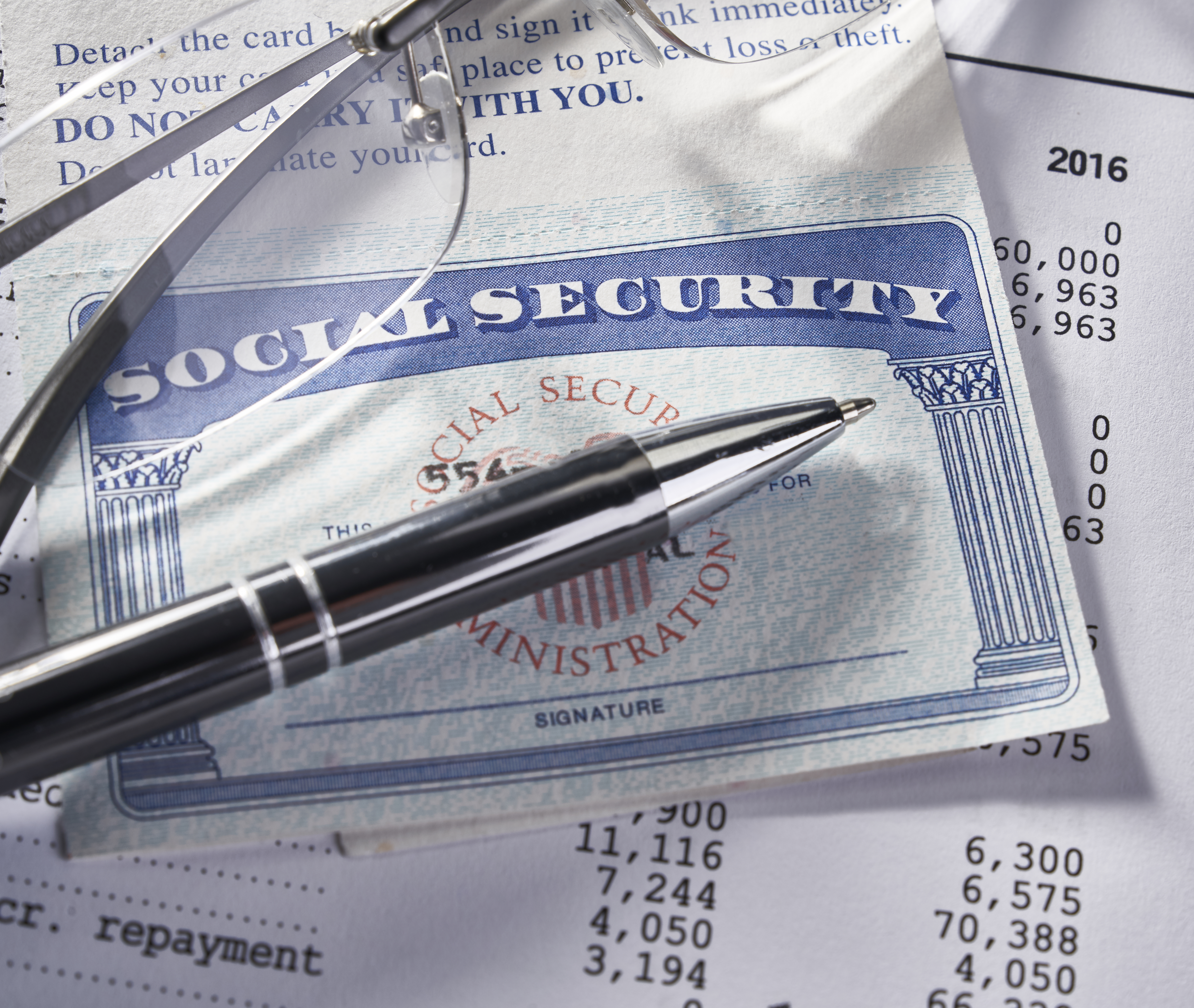 Social Security Card on IRS document with pen