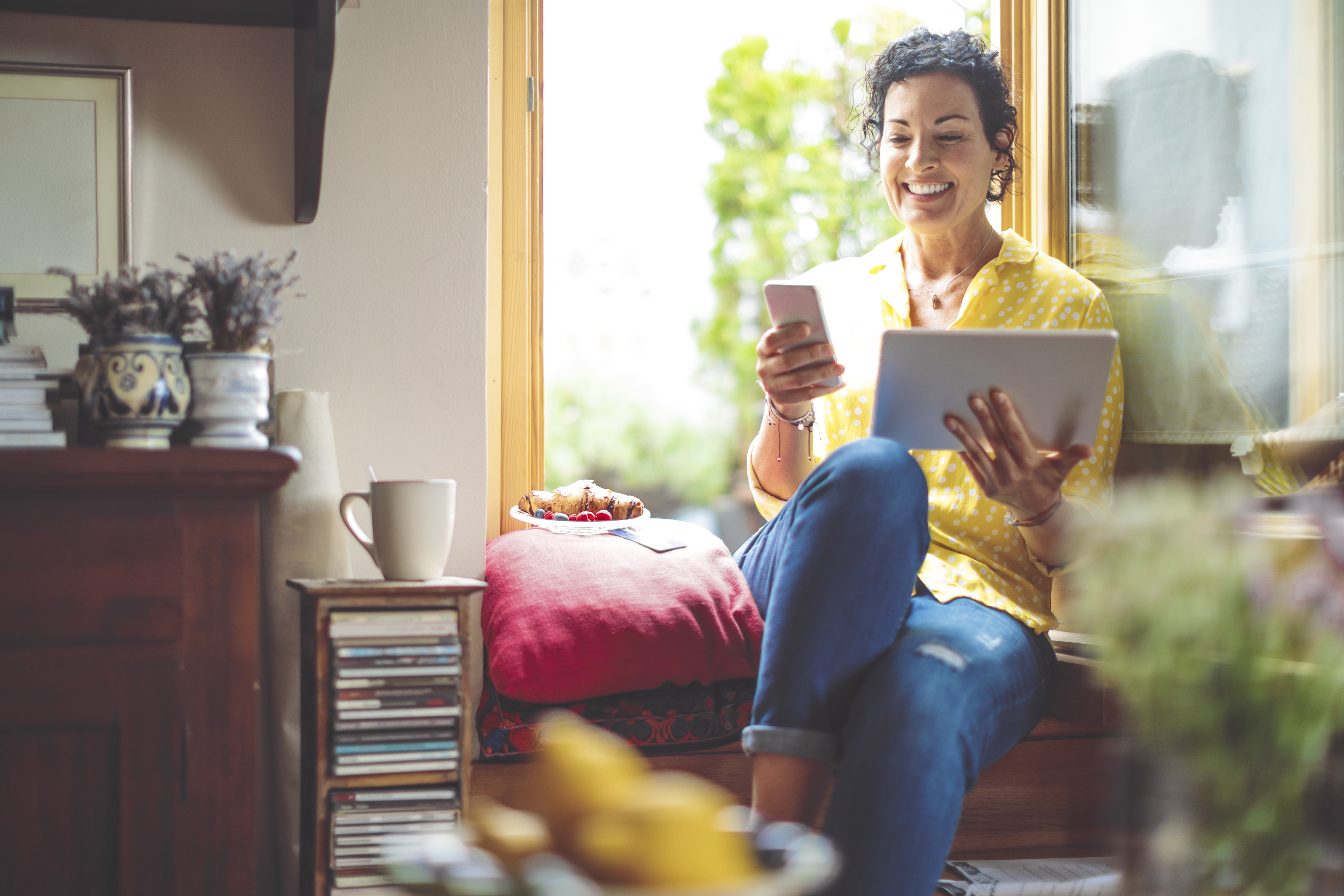 Woman searching iPhone and iPad for online events