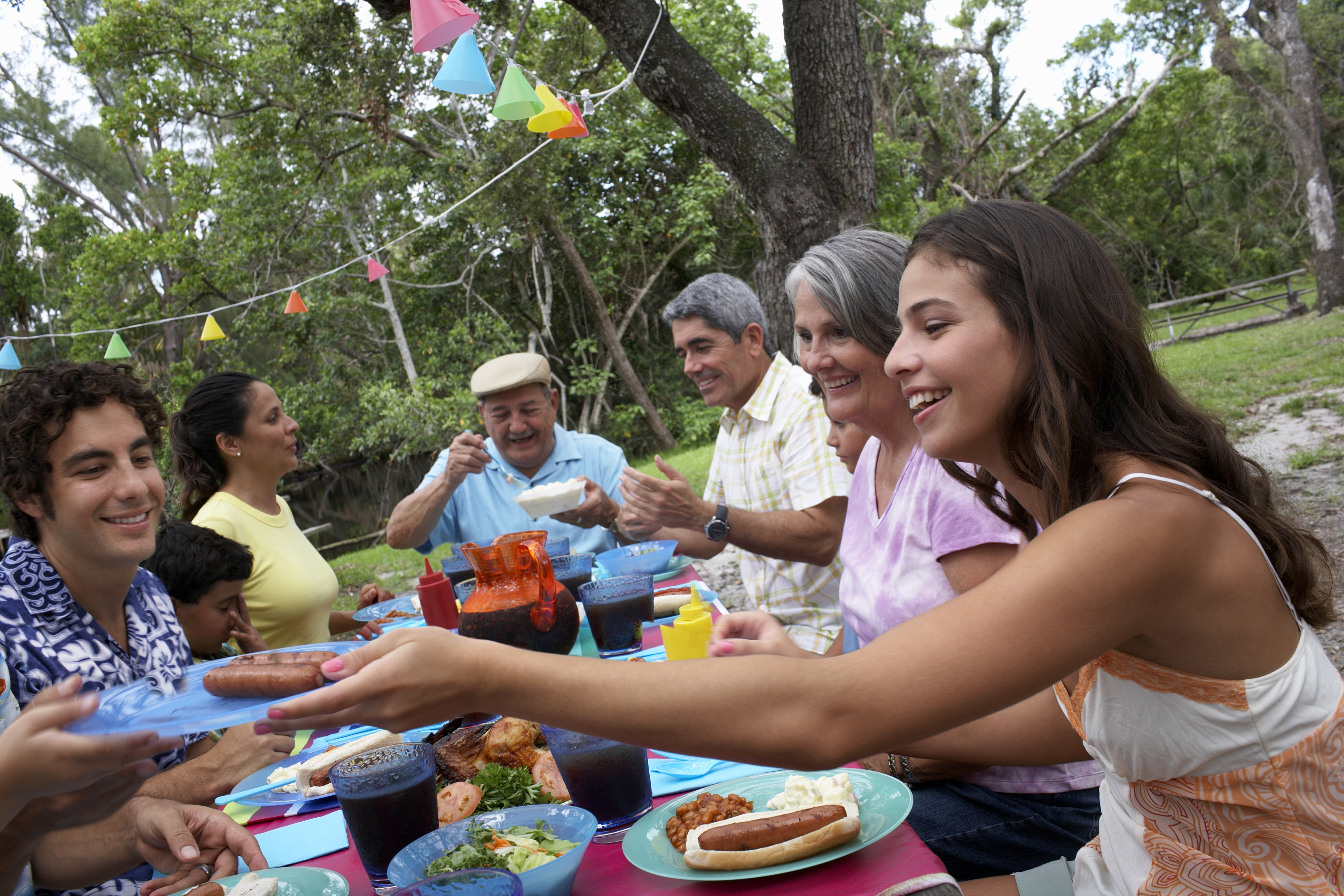 Multi-generational family eating outdoors