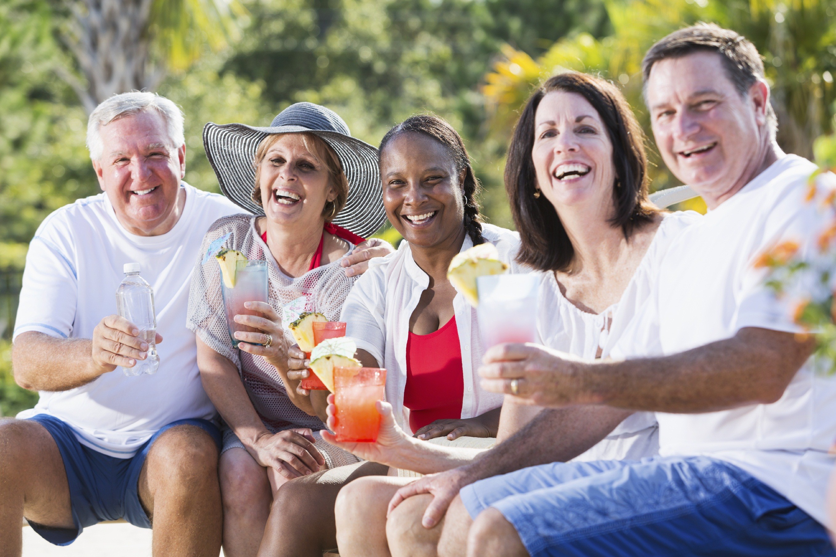 Mature adults enjoying tropical drinks