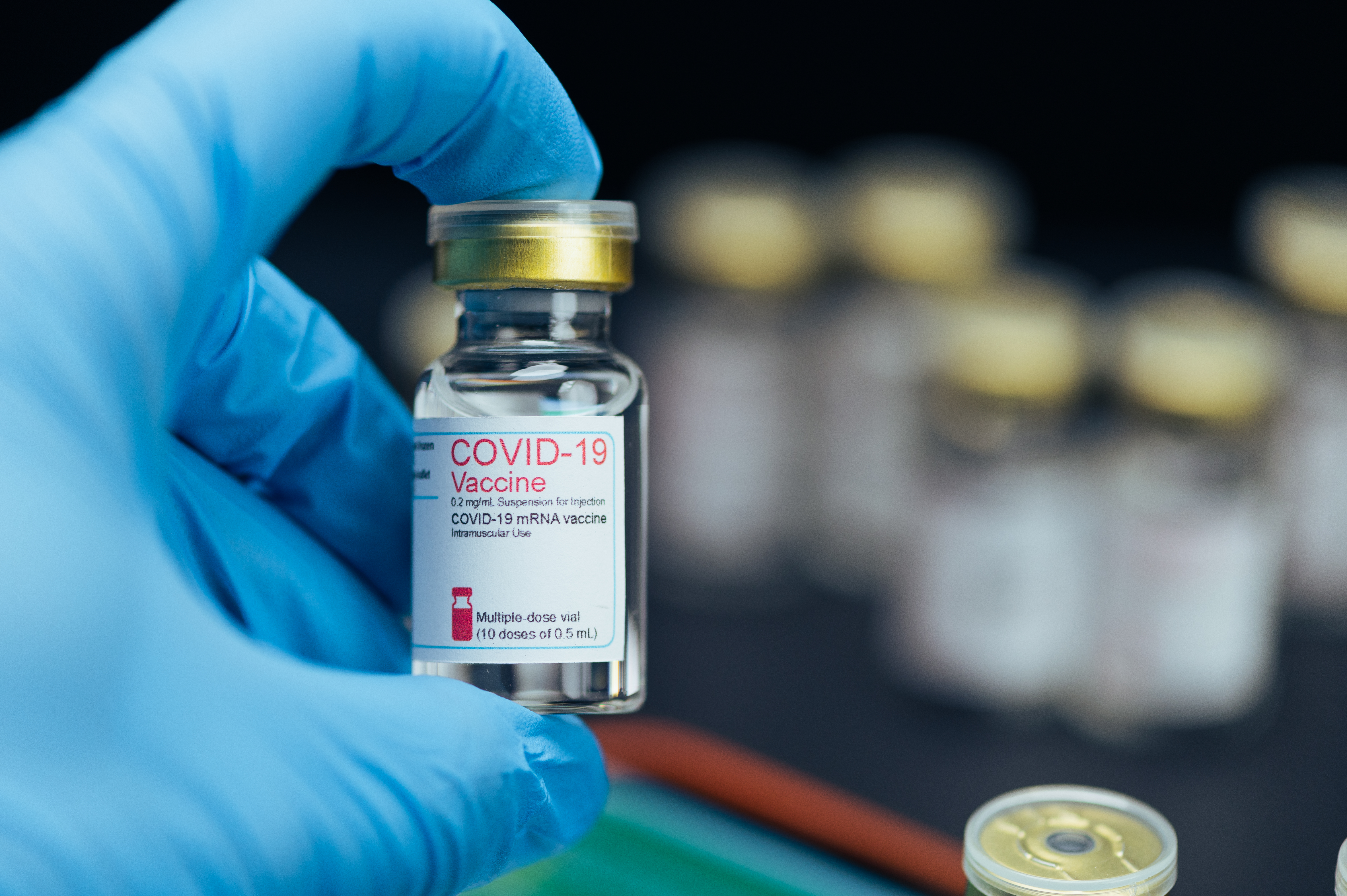 the close-up image of the COVID-19 bottle with the black backdrop