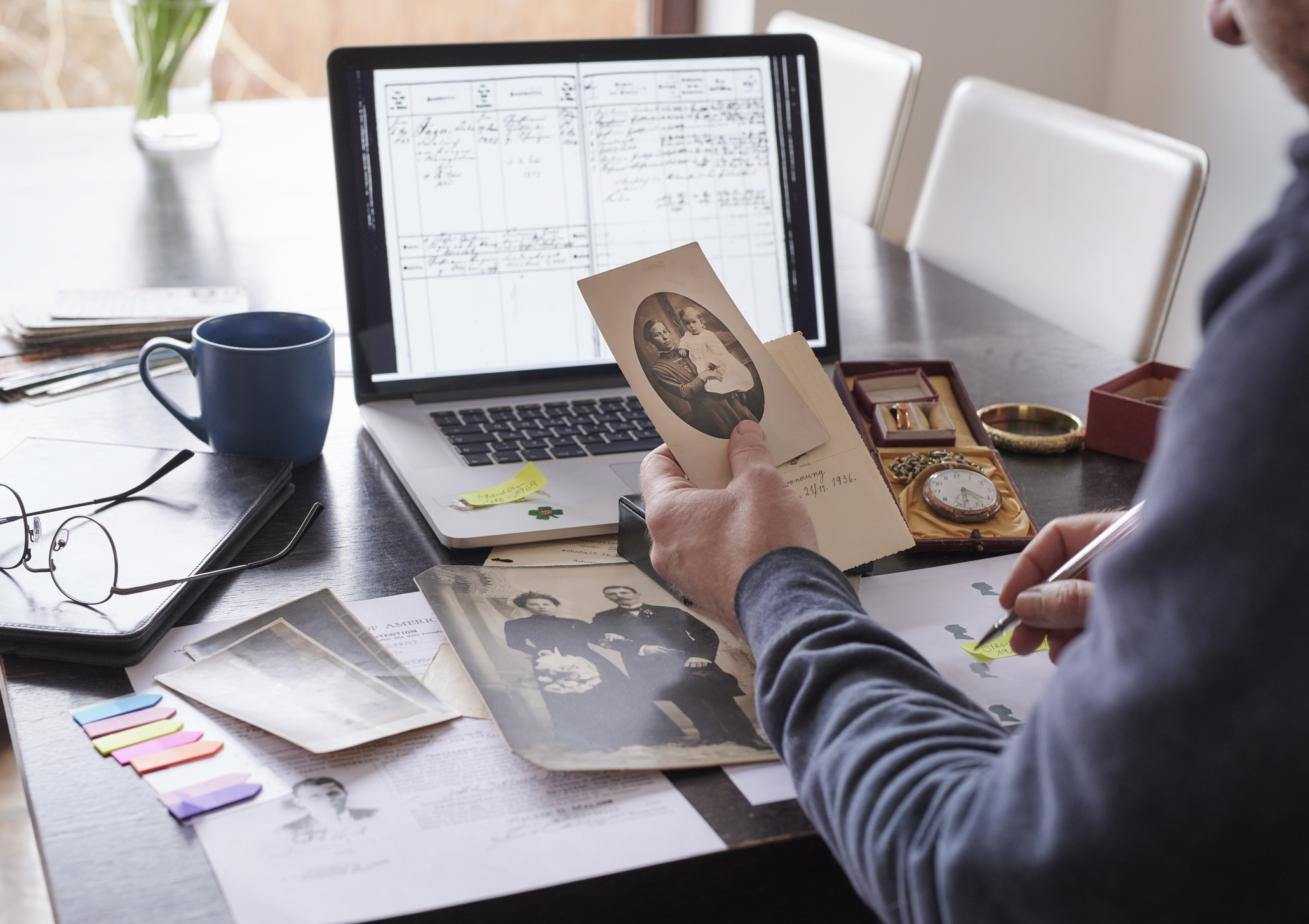 Woman at table looking at genealogical tree