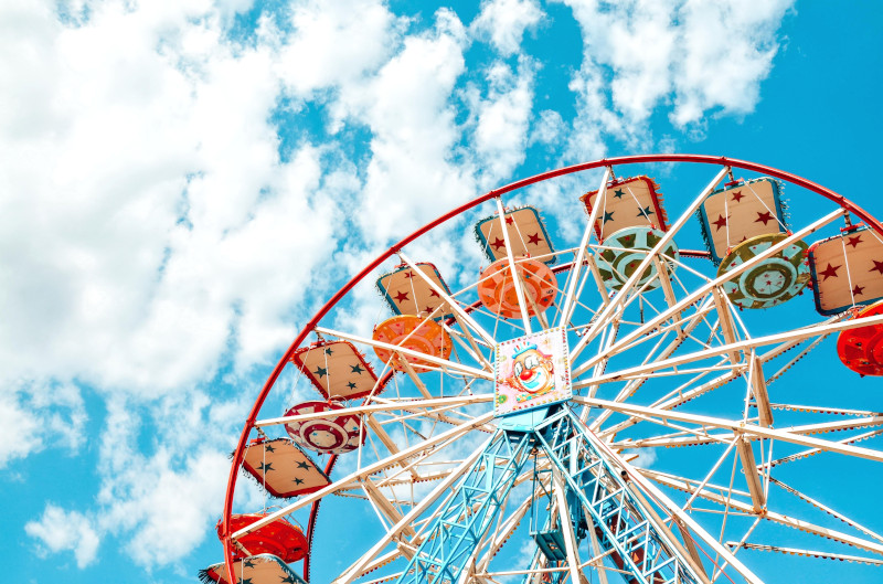 Low Angle View Of Ferris Wheel Against Blue Sky