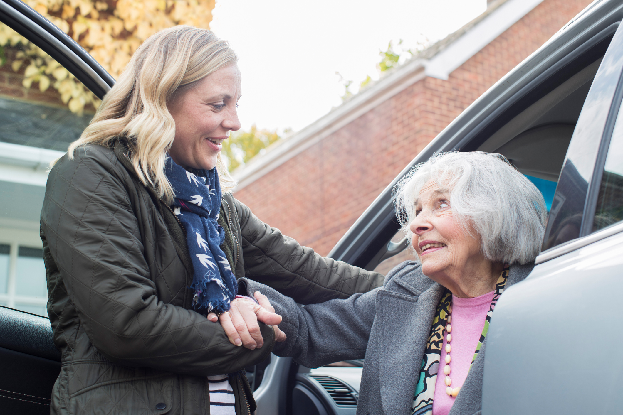 Female Neighbor Giving Senior Woman A Lift In Car