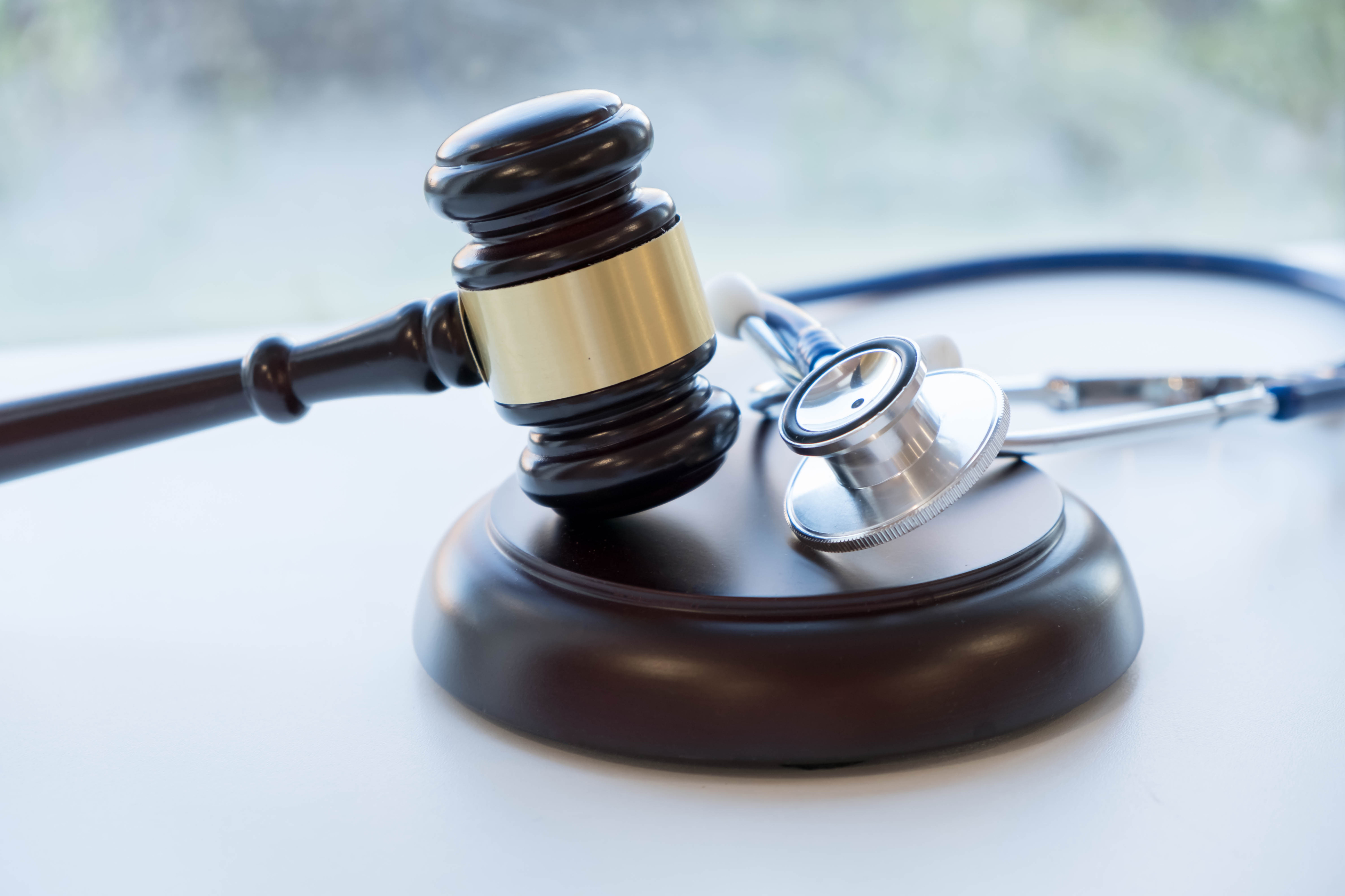 Gavel and stethoscope. medical jurisprudence. legal definition of medical malpractice. attorney. common errors doctors, nurses and hospitals make