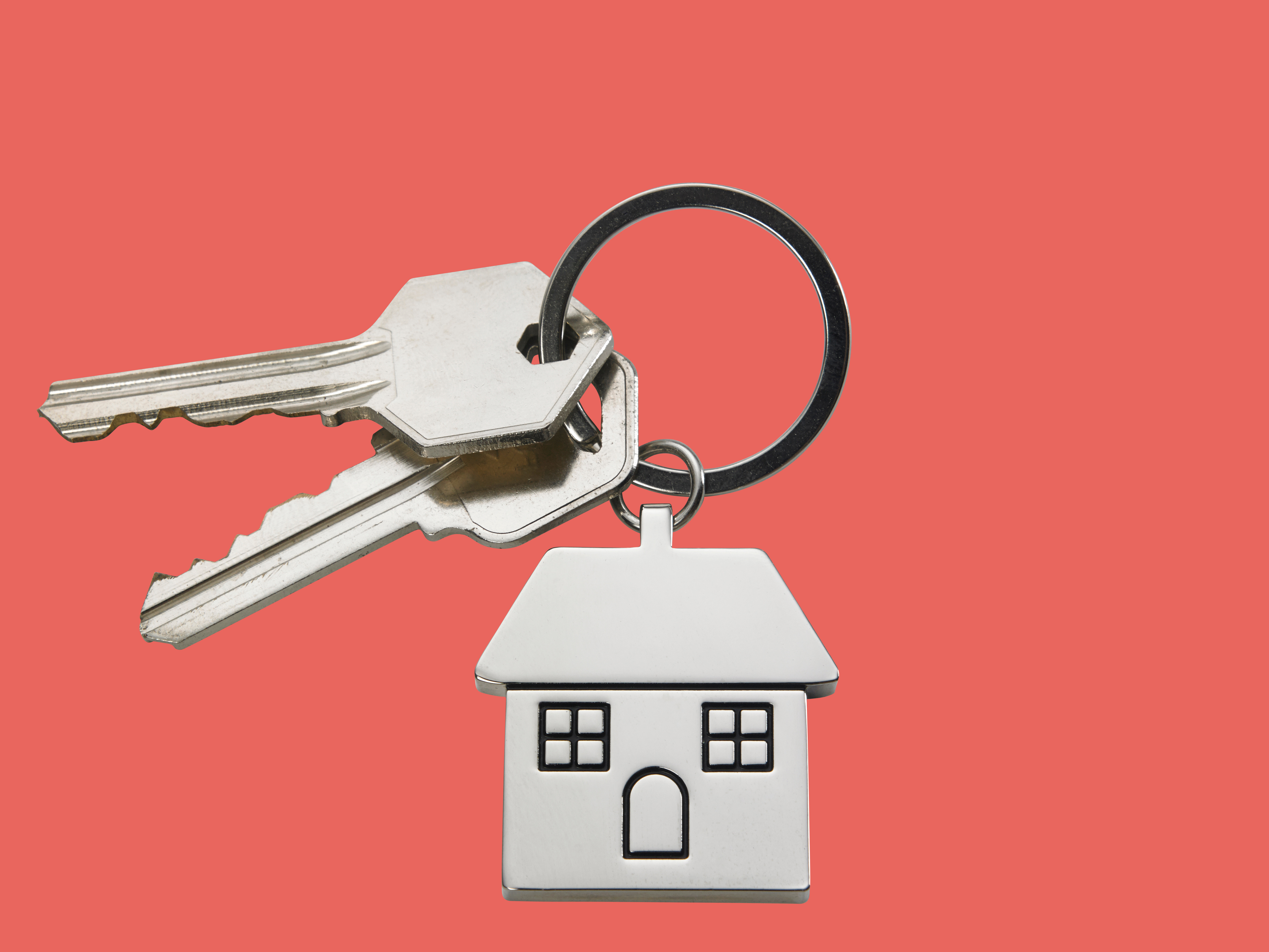 Close-Up Of House Keys Over White Background