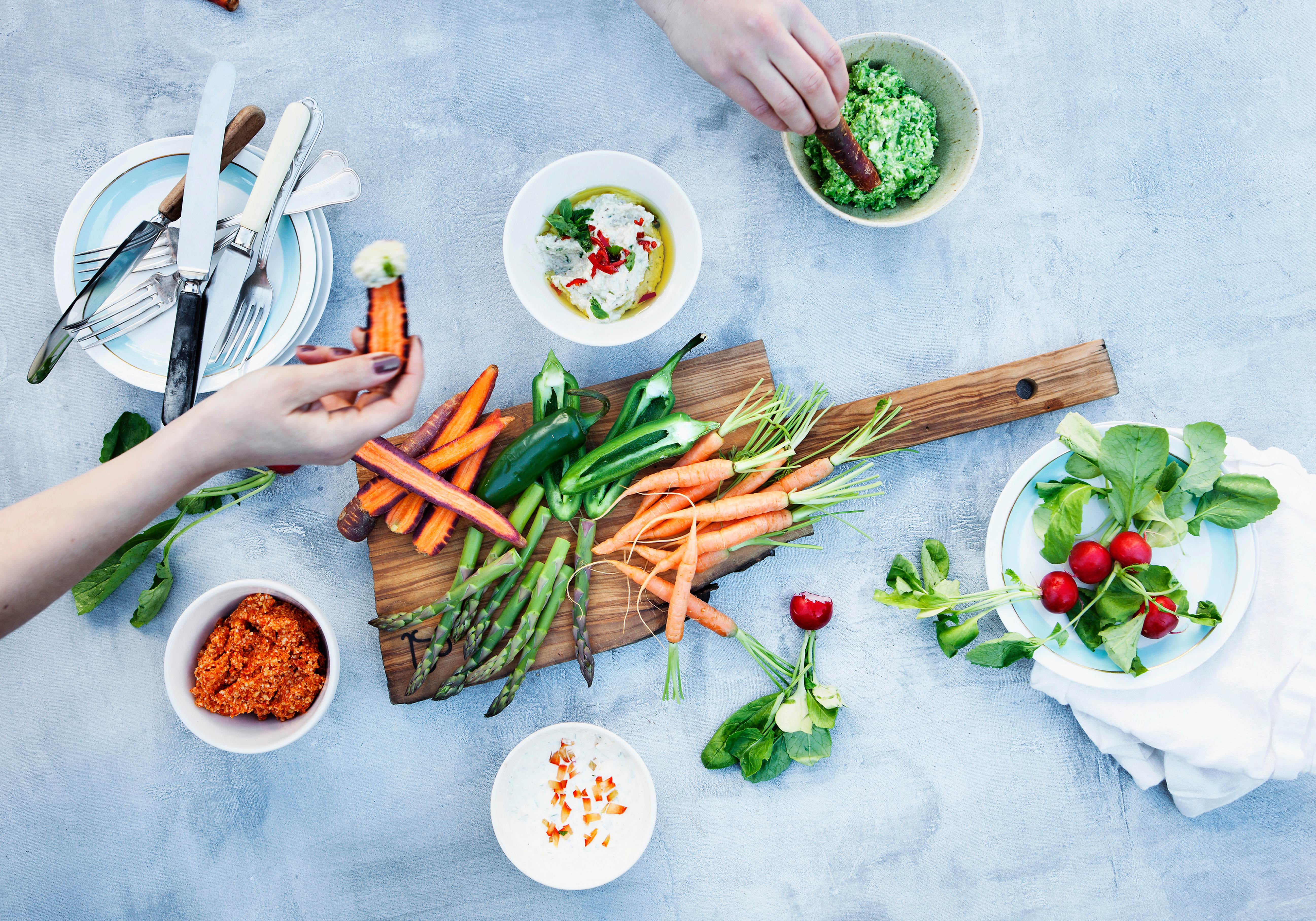 Board of vegetables with dips and sauces