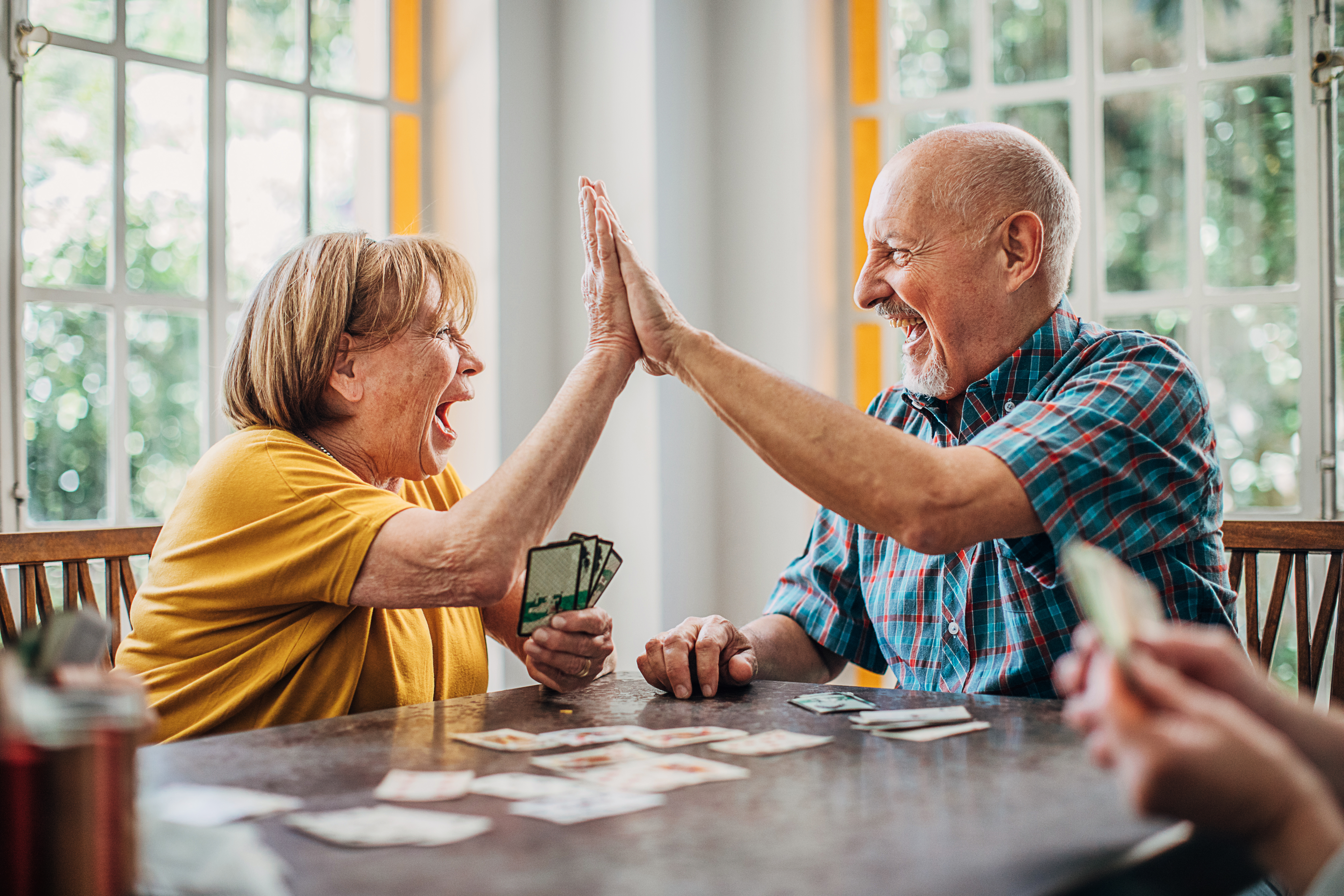 Senior couple playing cards in nursing home