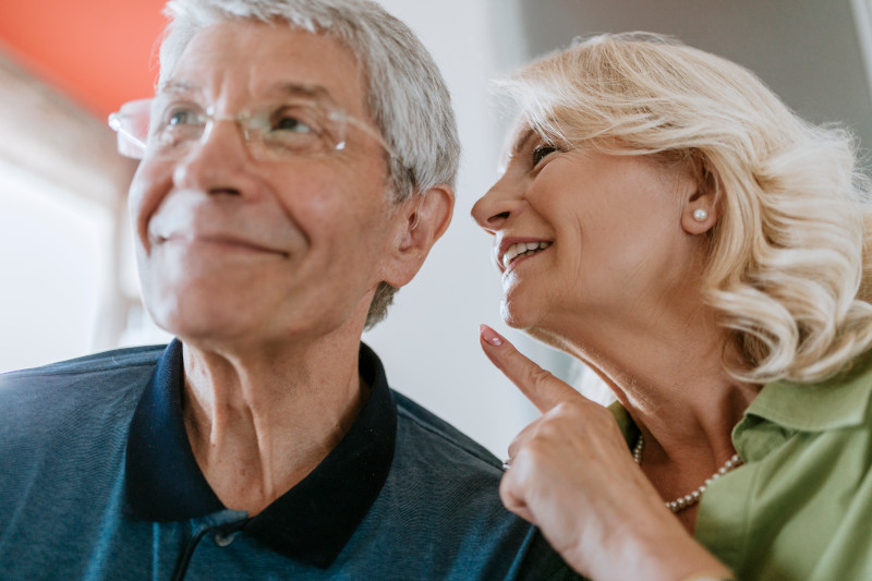 Senior woman talking to husband with hearing aid