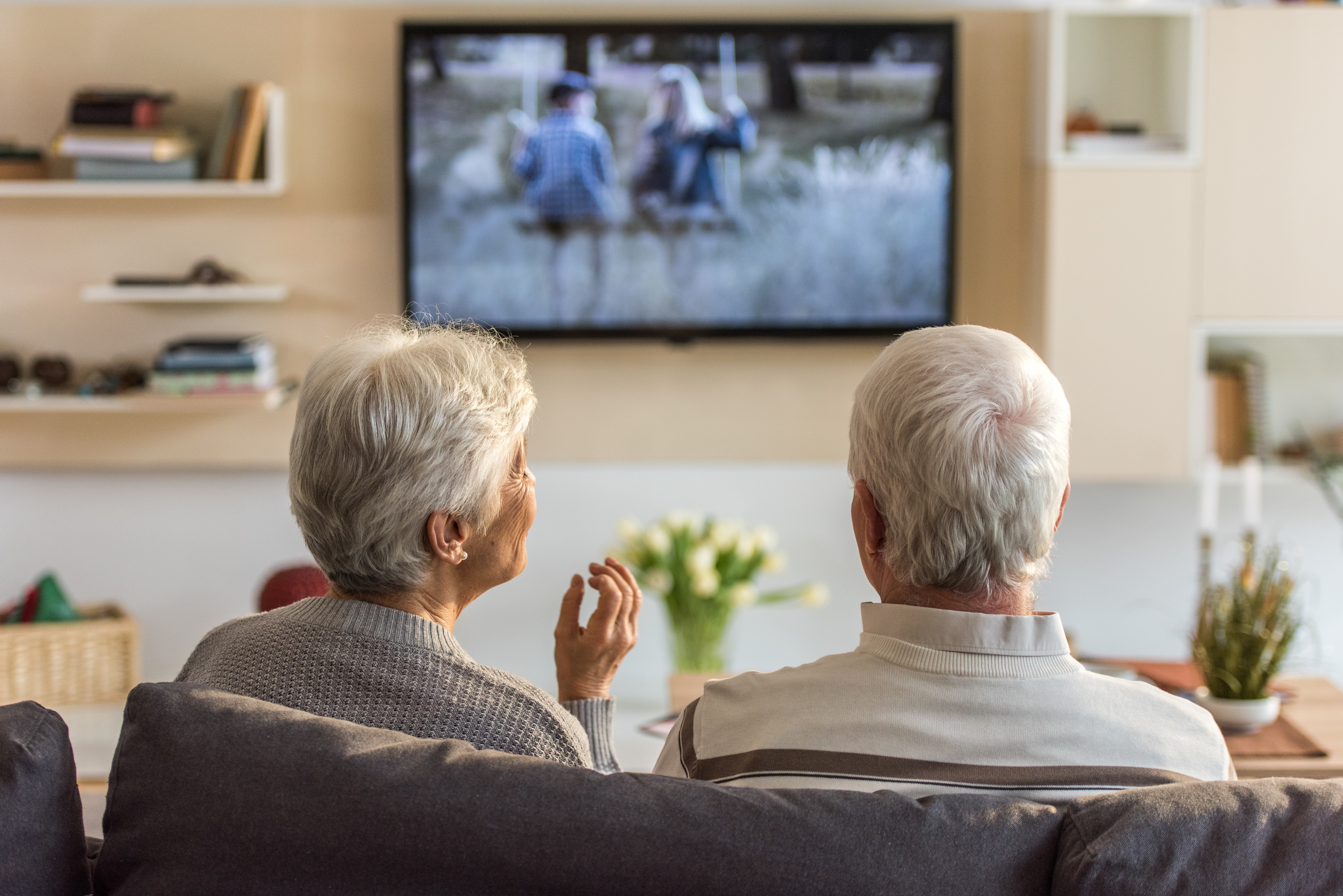 Senior couple watching television show