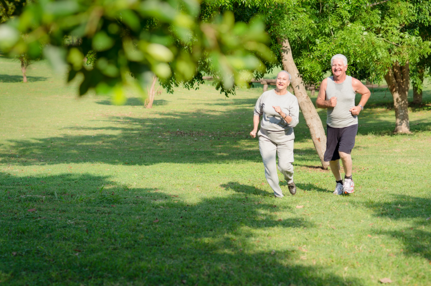 Active senior people jogging in city park