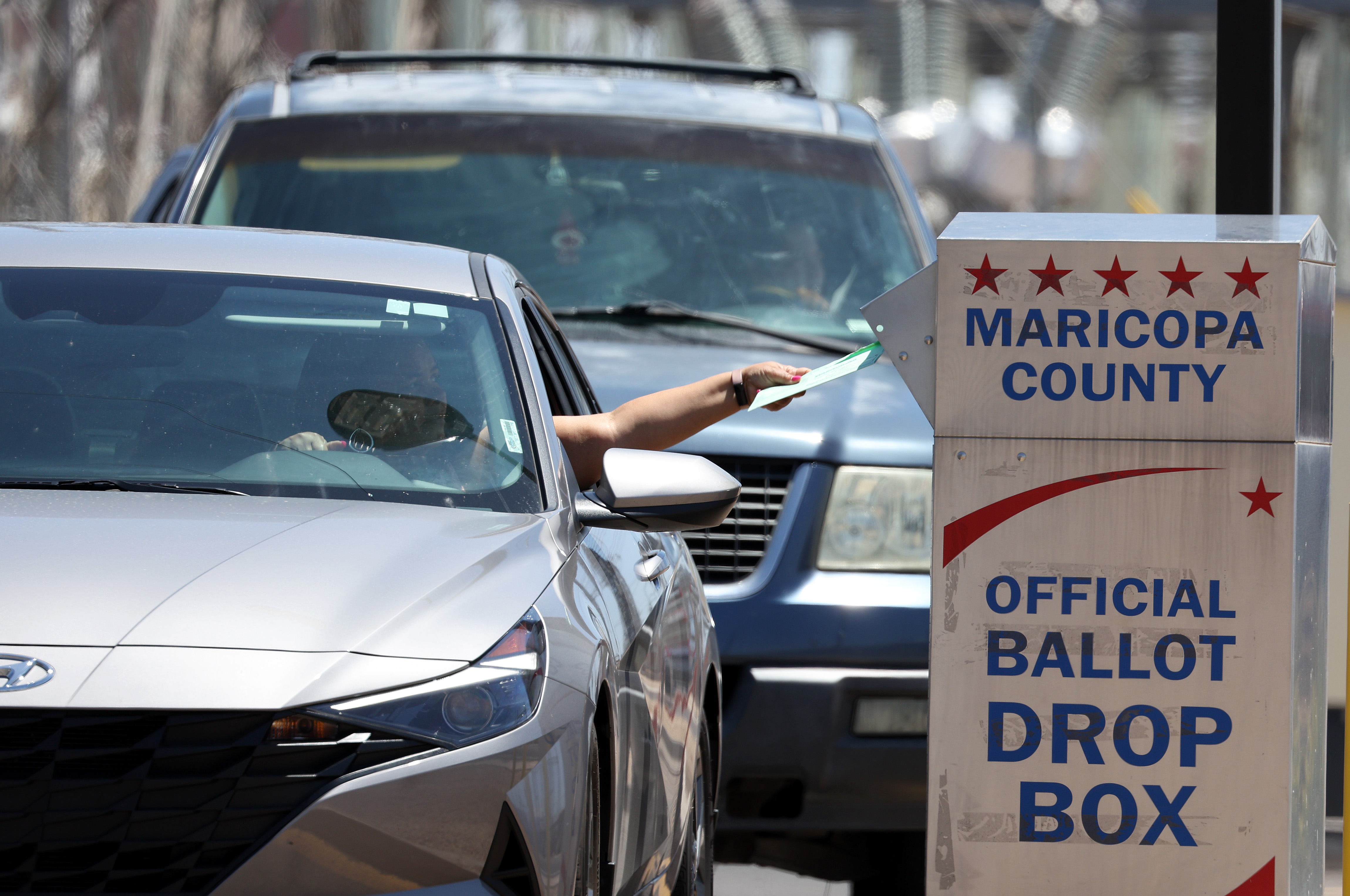 A voter places a ballot in a drop box outside of the Maricopa County Elections Department on August 02, 2022 in Phoenix, Arizona. Arizonans are heading to the polls to vote in the state's midterm primary election.