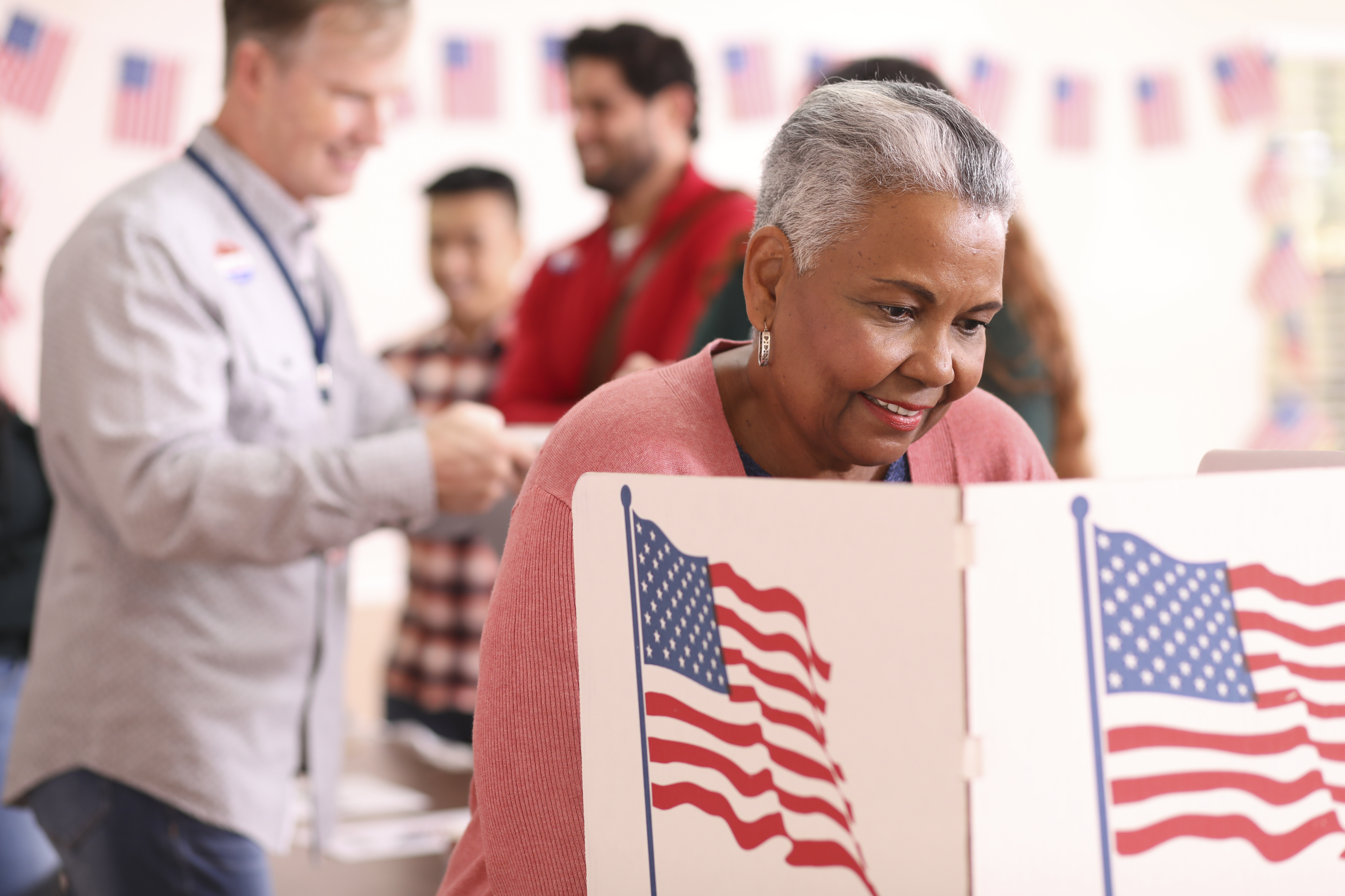 Senior adult, African descent woman votes in USA election.