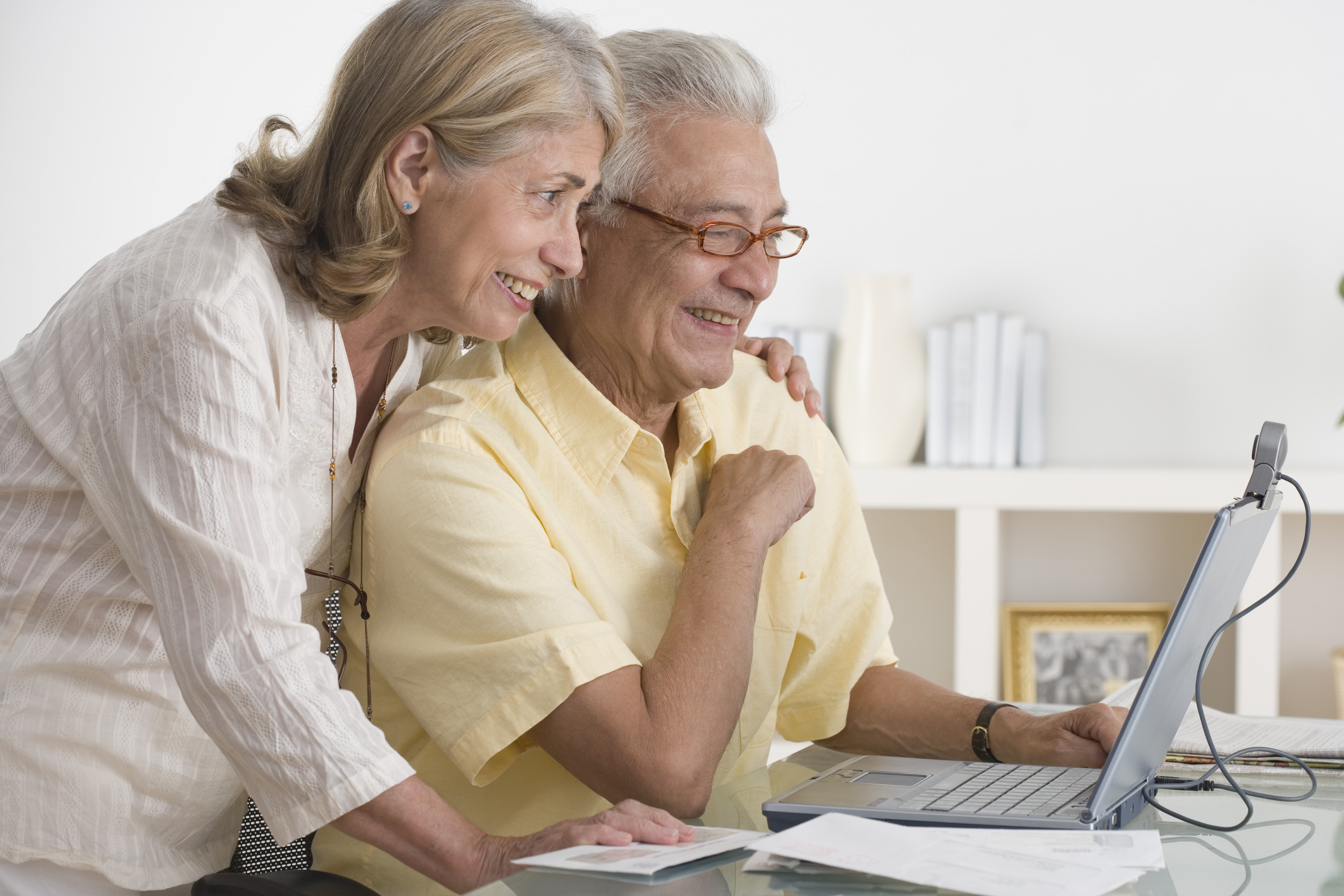 Senior Couple Using Webcam on Laptop