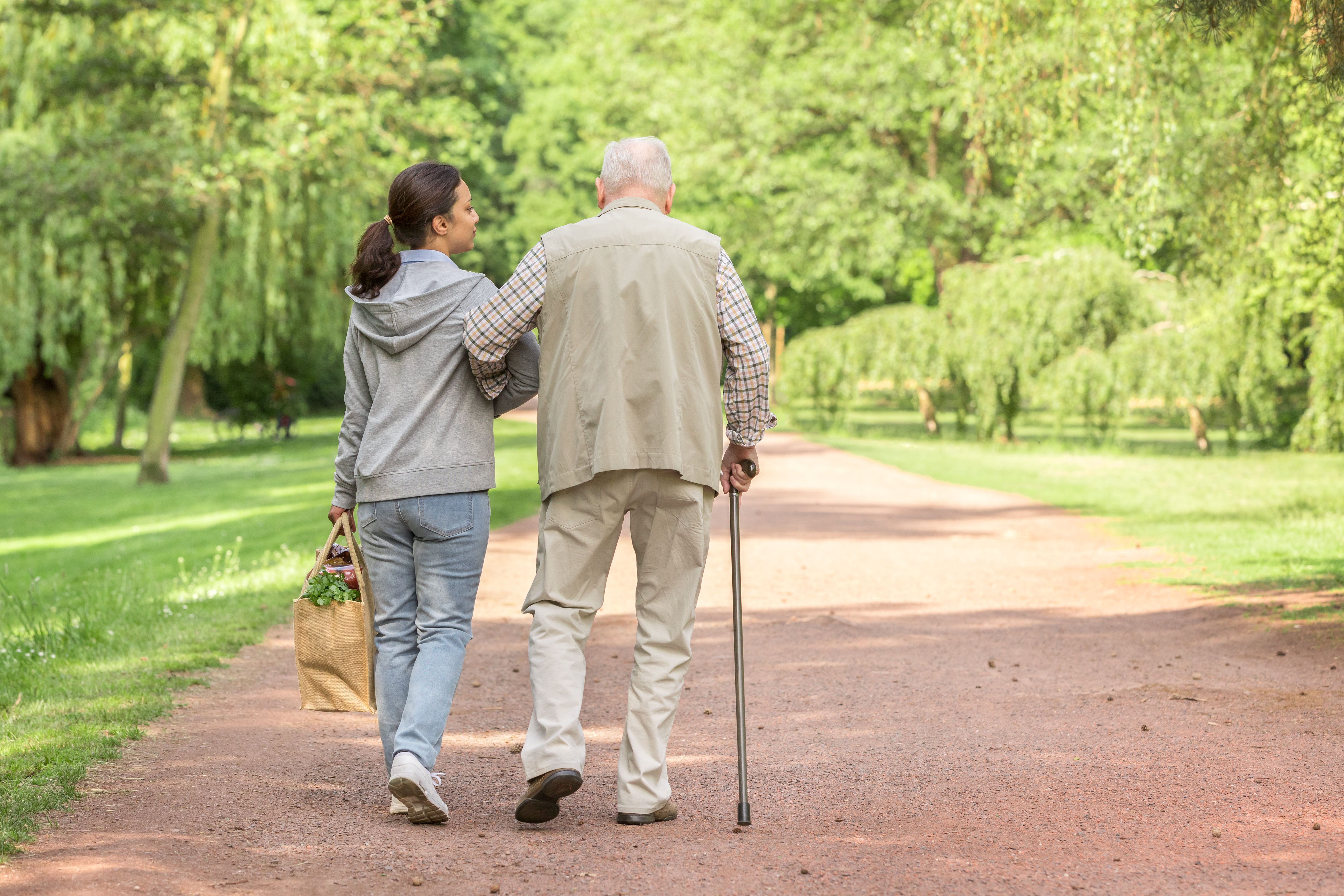 Caregiver – woman helping senior man with shopping