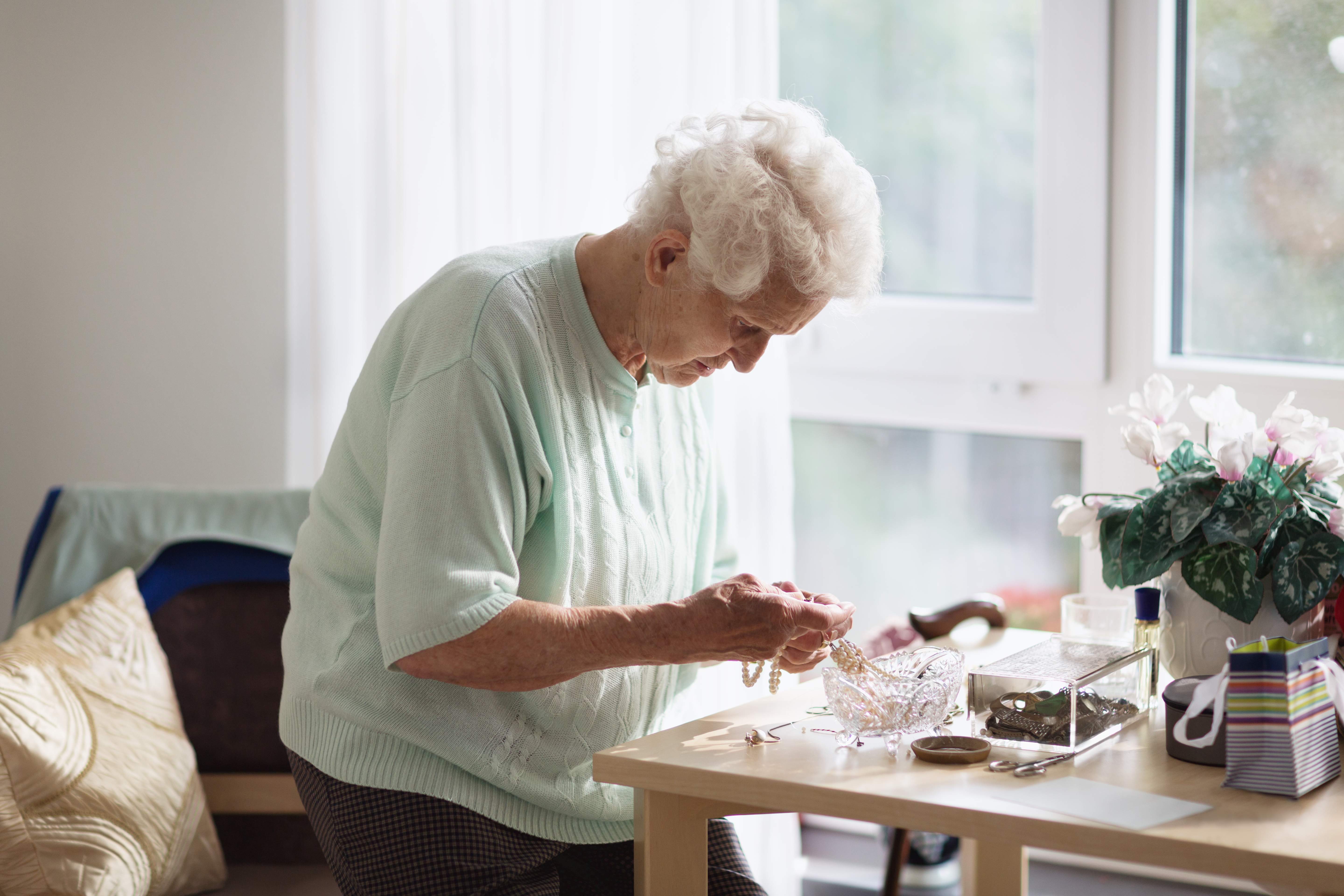 Alzheimers disease: senior woman sorting her jewelry